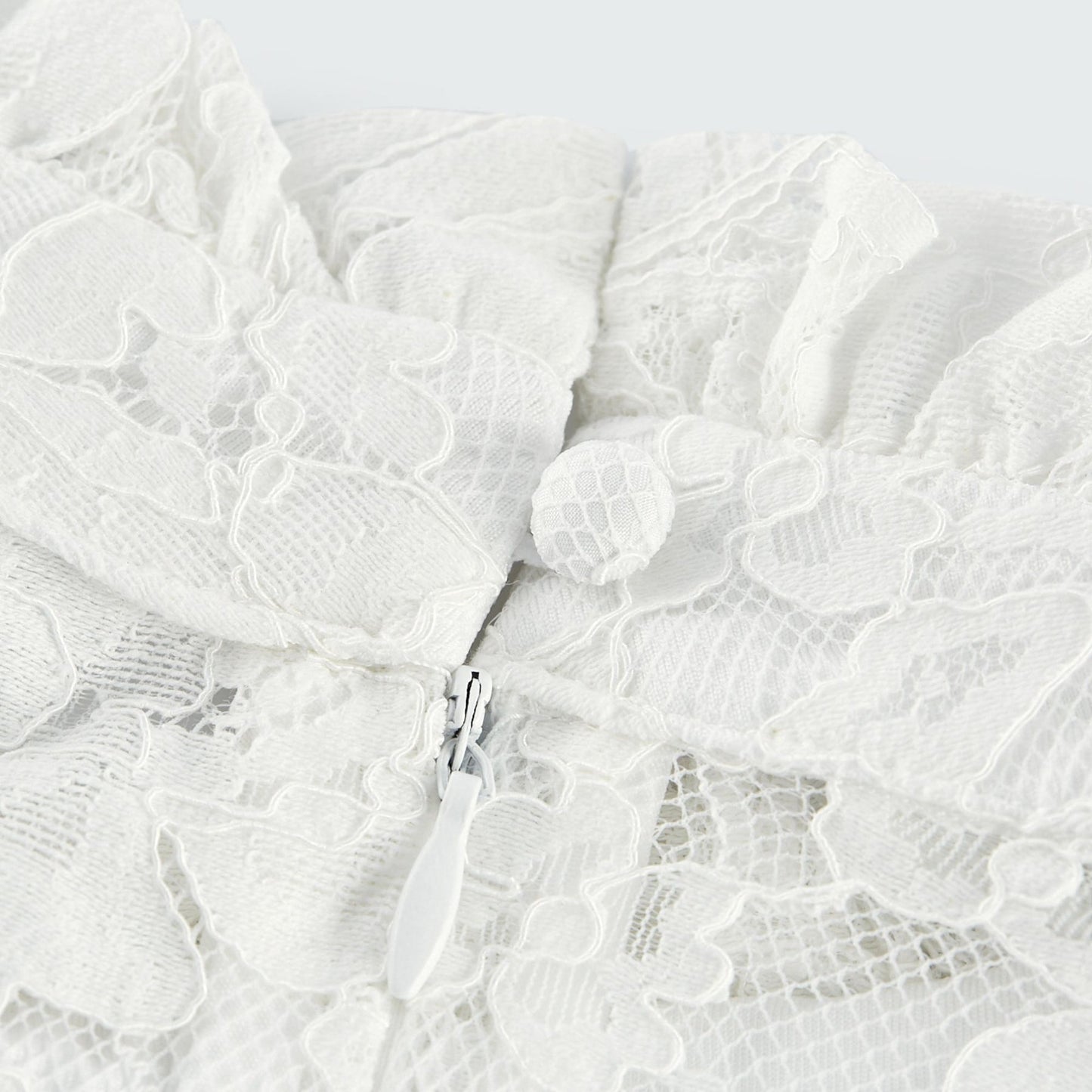 A beige lace midi dress with cutout details featuring a Celine design