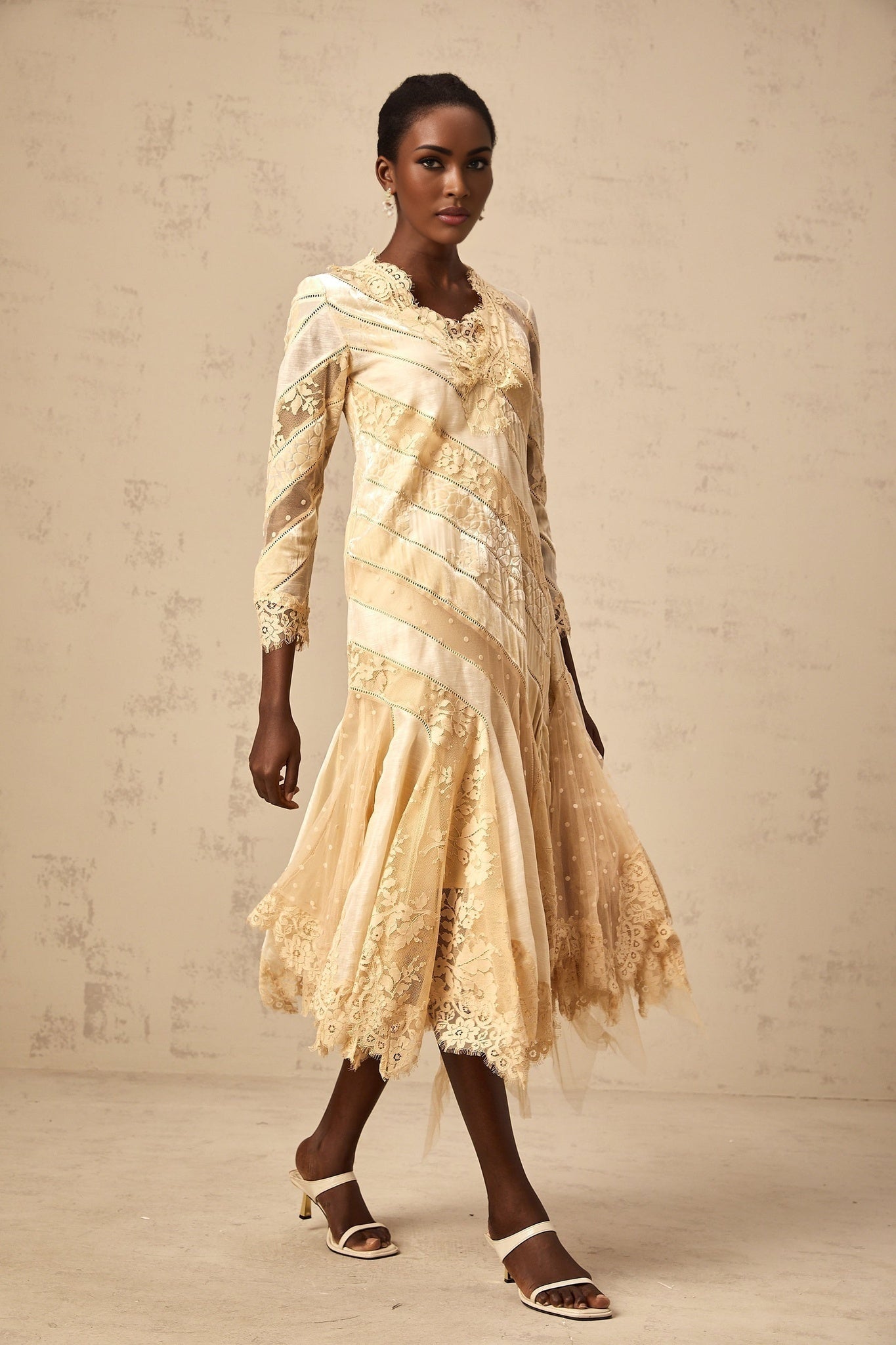 A beige midi dress with diagonal stripes and panelled design called Ingrid