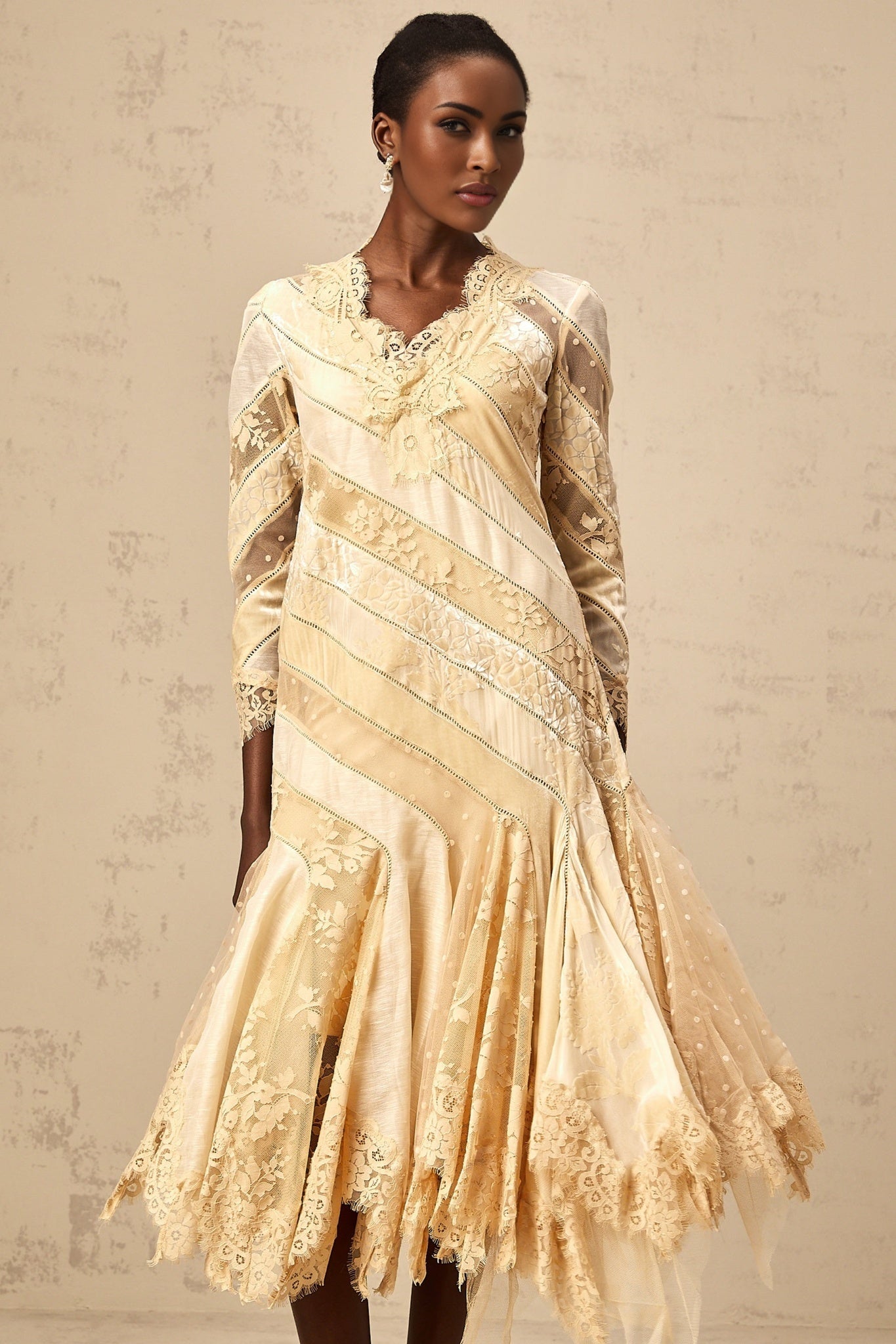A beige midi dress with diagonal stripes and panelled design named Ingrid