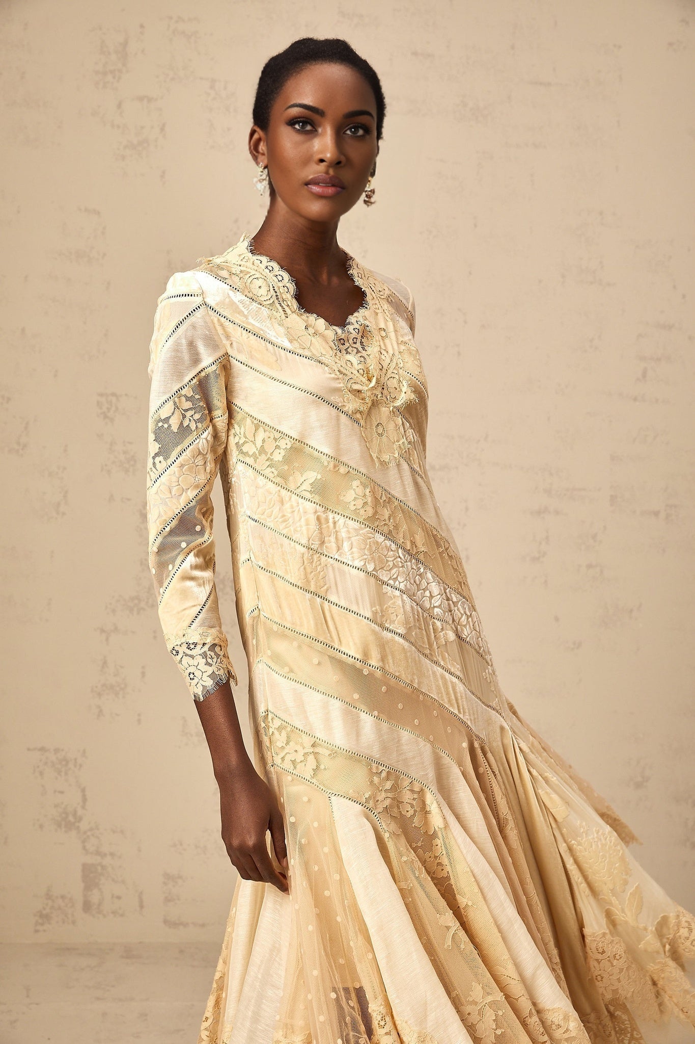 A beige midi dress with diagonal stripes and panelled design named Ingrid