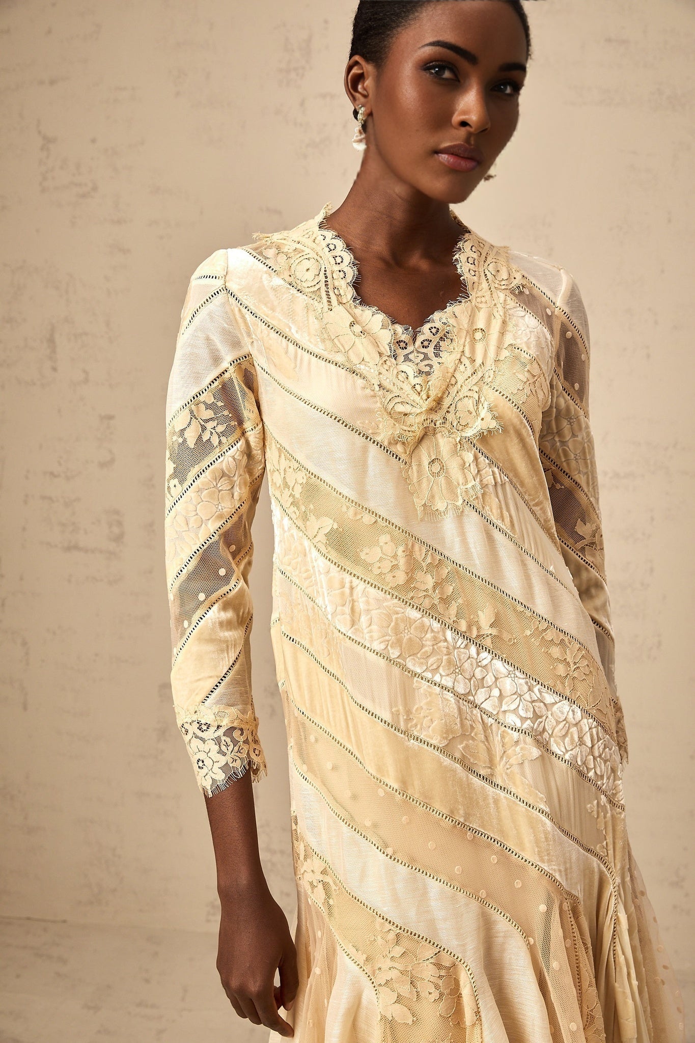 A beige midi dress with diagonal stripes and panels named Ingrid