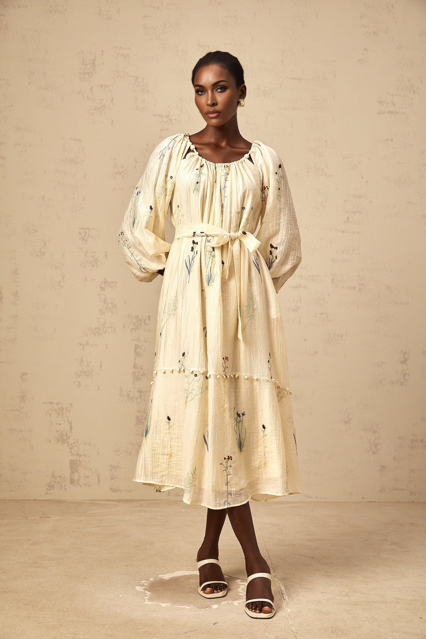 A beige midi dress with flower embroidery and beaded details called Uranie