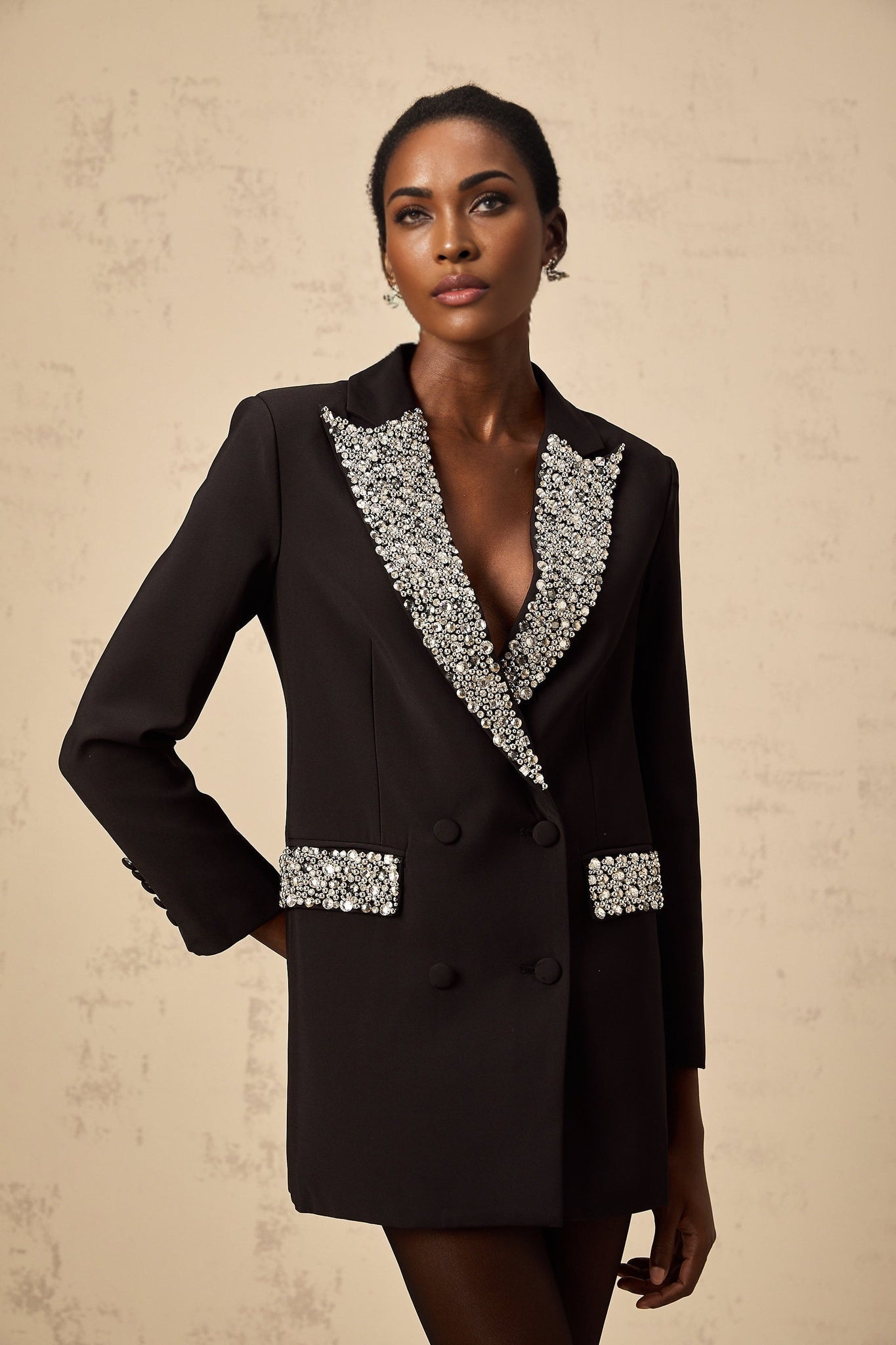 A black blazer adorned with sparkling crystal embellishments featuring a tailored fit and elegant design
