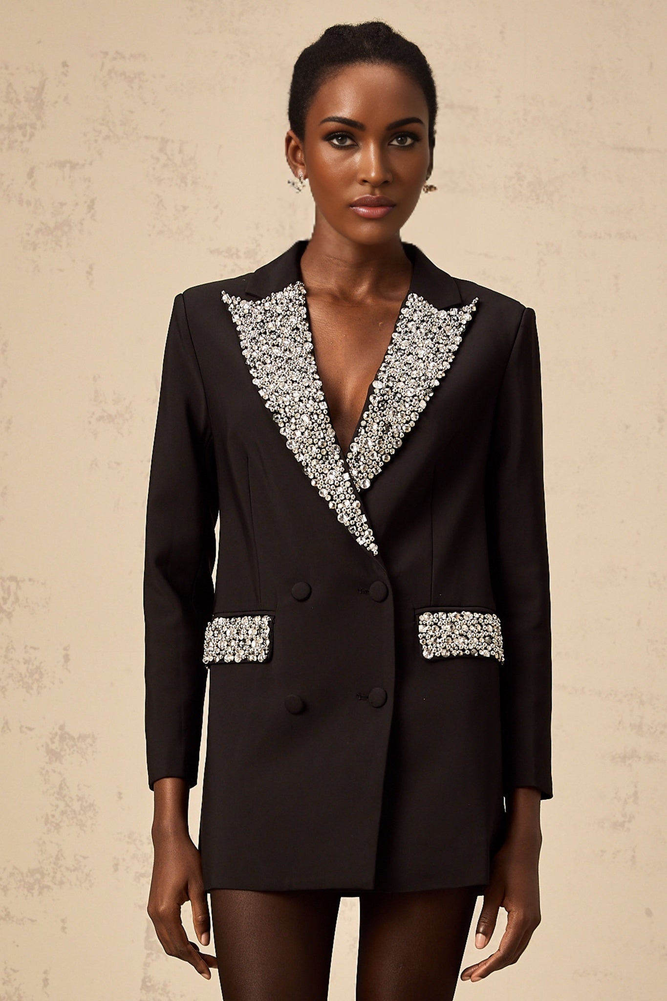 A black blazer adorned with sparkling crystal embellishments featuring a tailored fit and elegant design