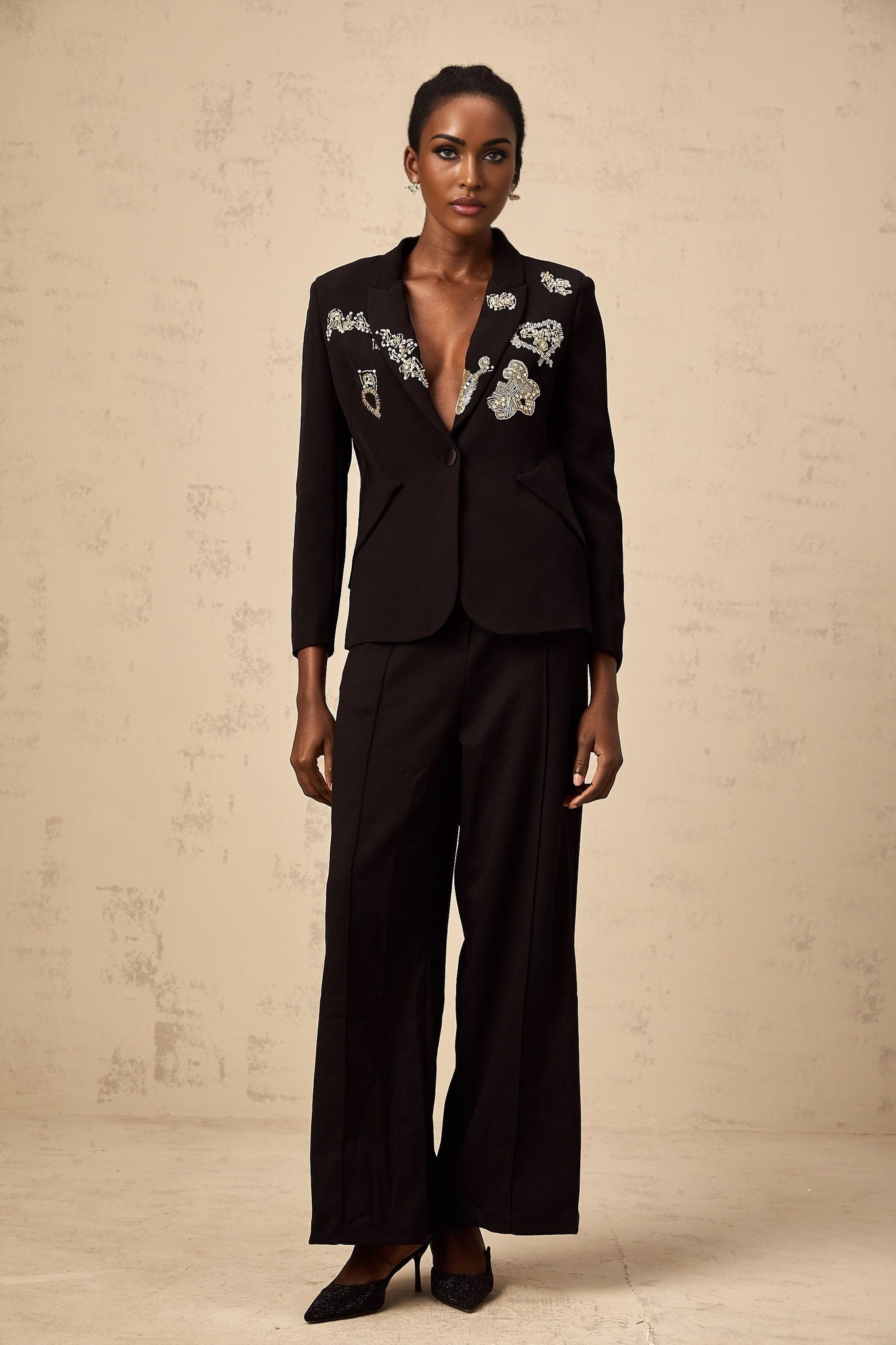 A black blazer featuring intricate bead embroidery details named Ximena