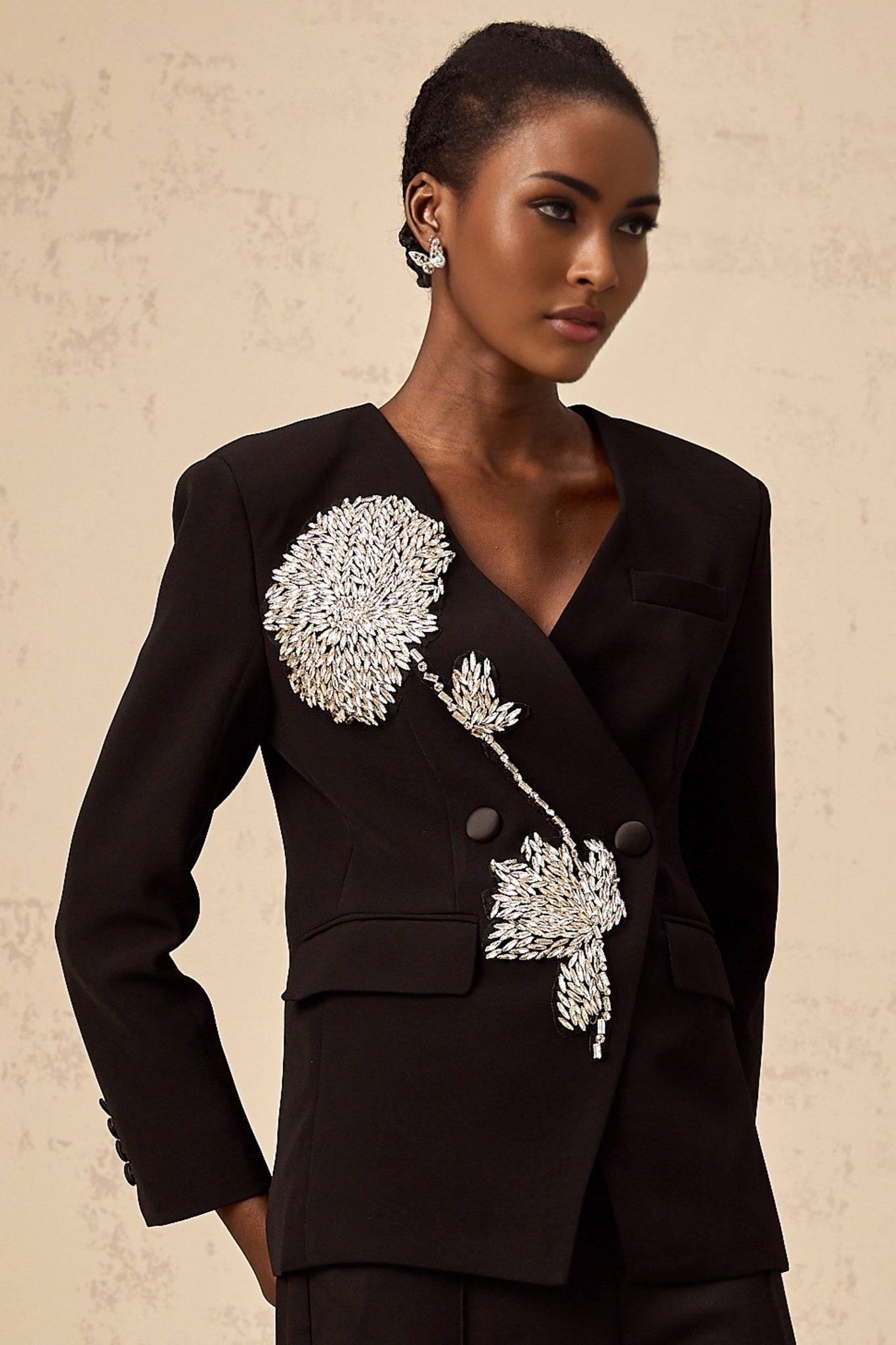A black blazer with a floral pattern featuring embellished flower motifs named Therese
