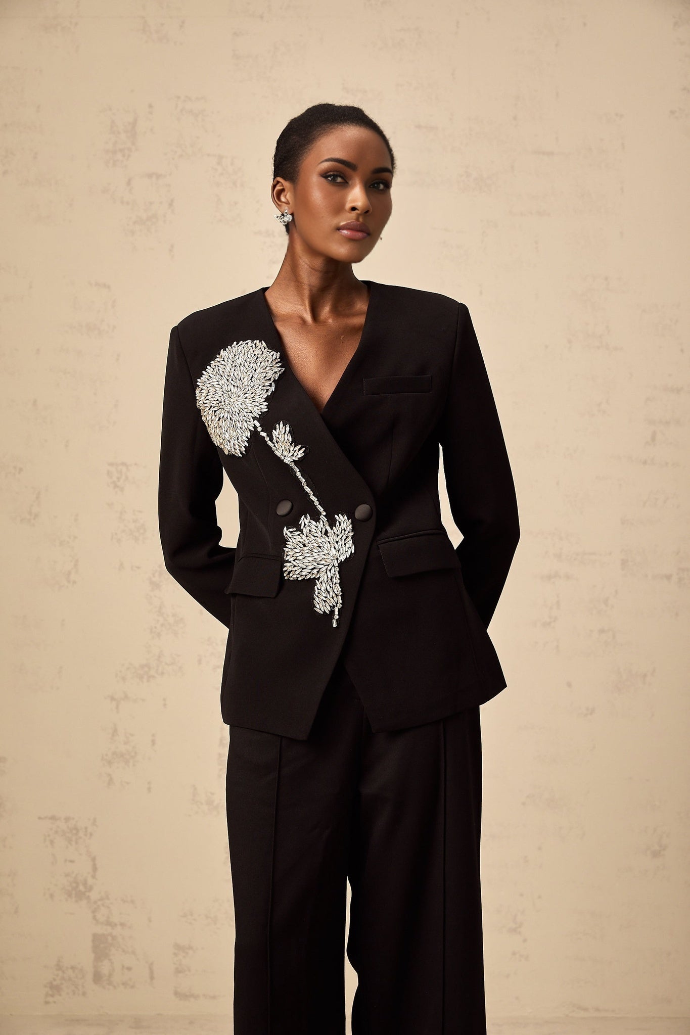 A black blazer with a floral pattern featuring embellished flower motifs named Therese
