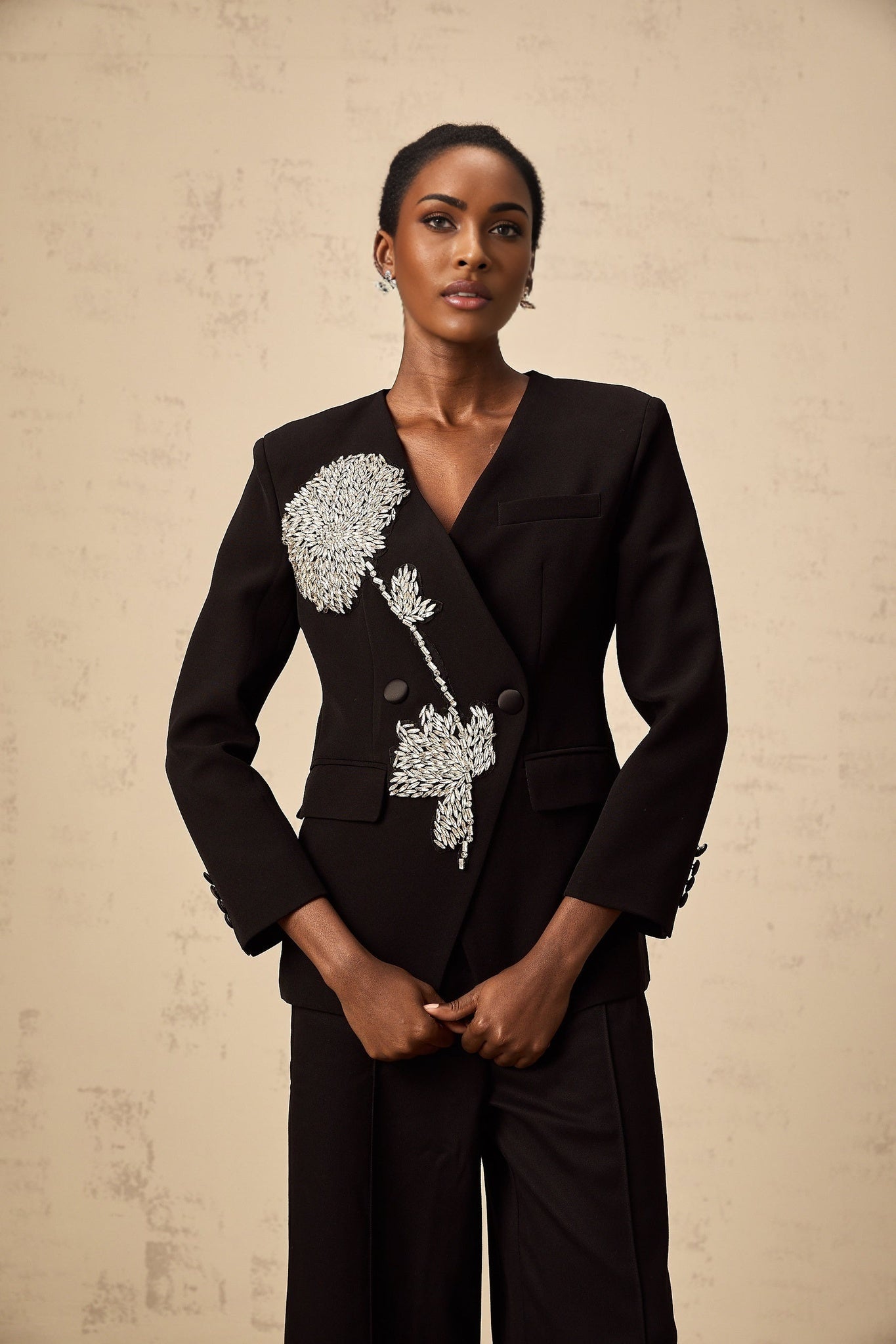 A black blazer with a floral pattern featuring embellished flower motifs named Therese