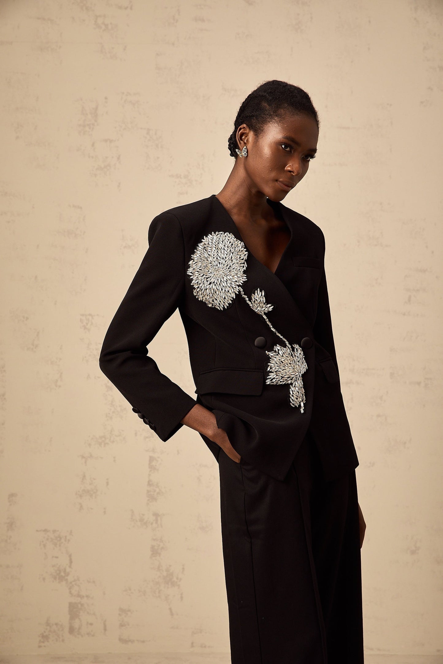 A black blazer with an allover floral pattern featuring embellished flower motifs