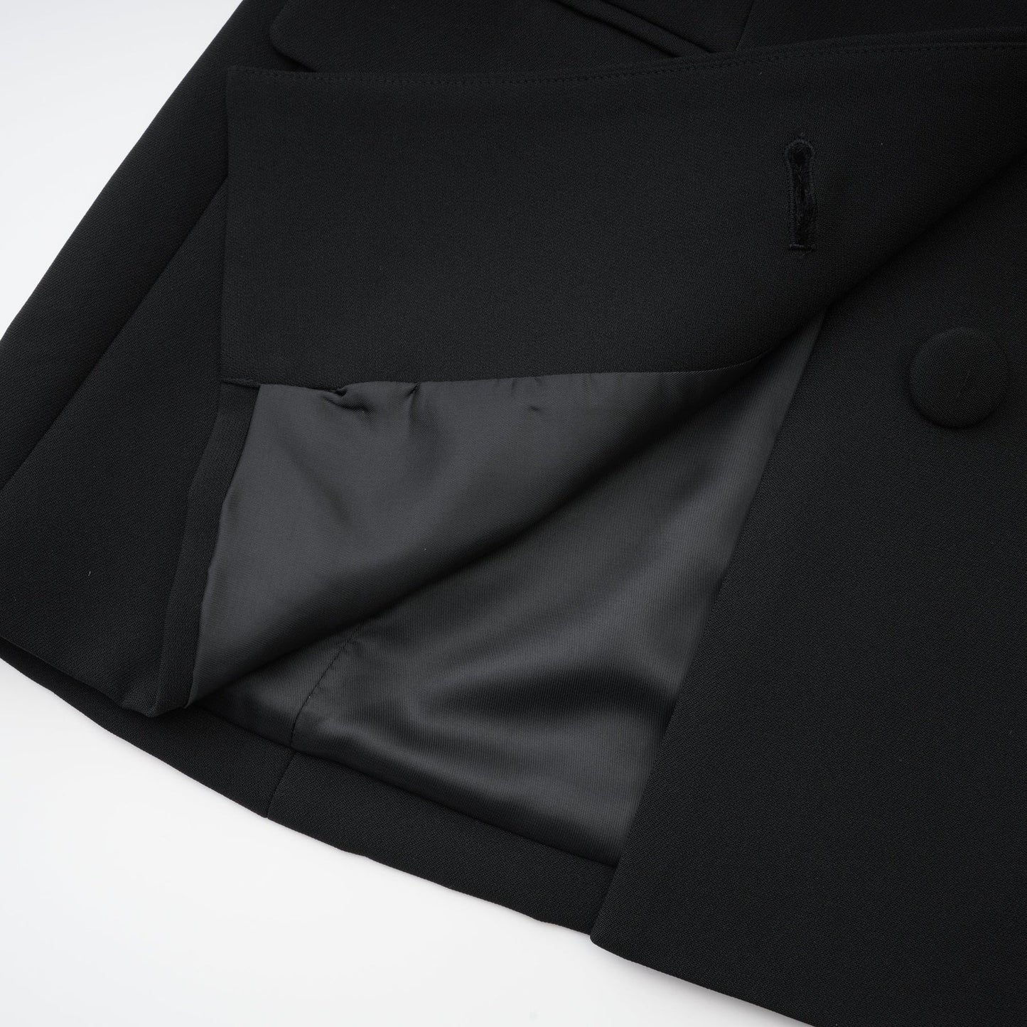 Black dress with long sleeves notched lapels scoop back buttoned cuffs fitted waistline crystal embellishment and front button fastening Made of 100% Polyester