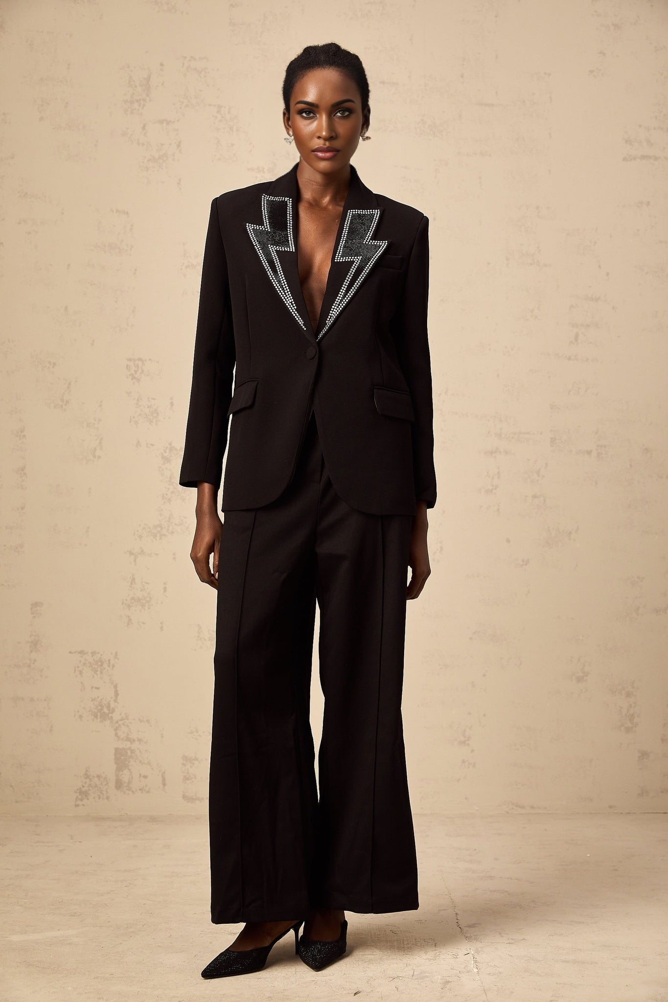 A black blazer with crystal embellishments in the shape of lightning bolts