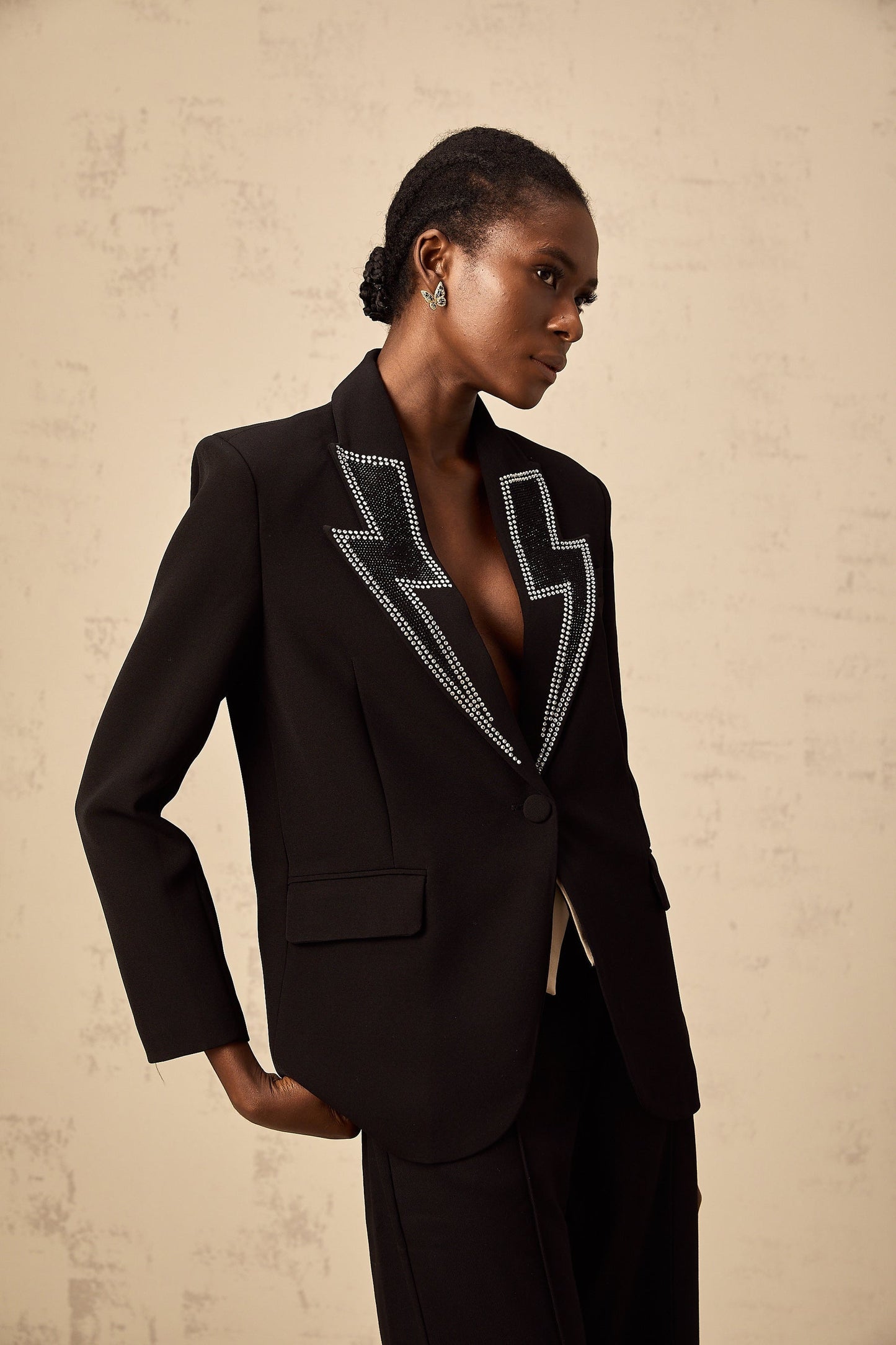 A black blazer with crystal embellishments in the shape of lightning bolts