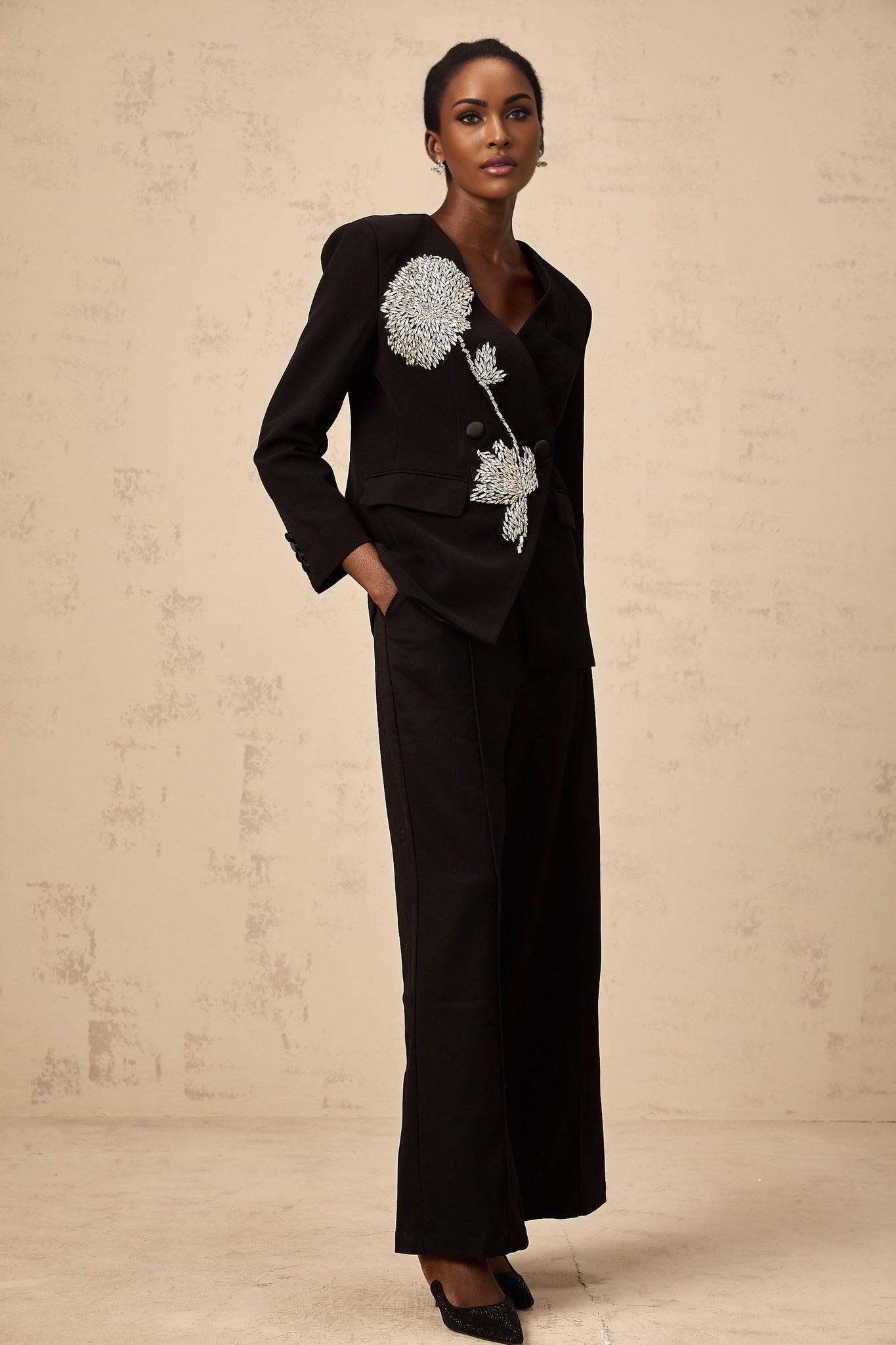 A black blazer with floral embellishments featuring Therese design