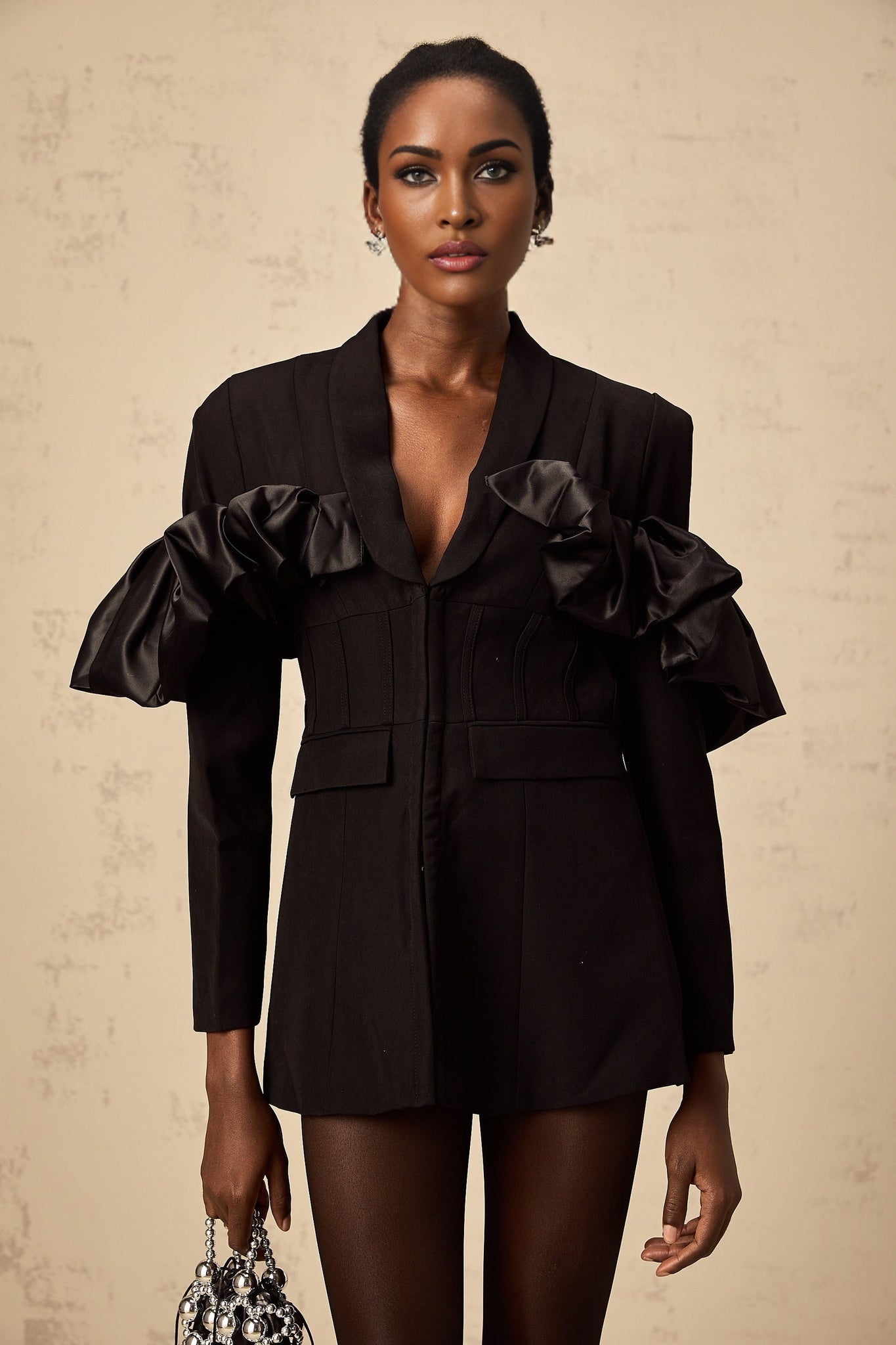 A black blazer with panelled design and boned structure featuring a tailored fit and structured silhouette