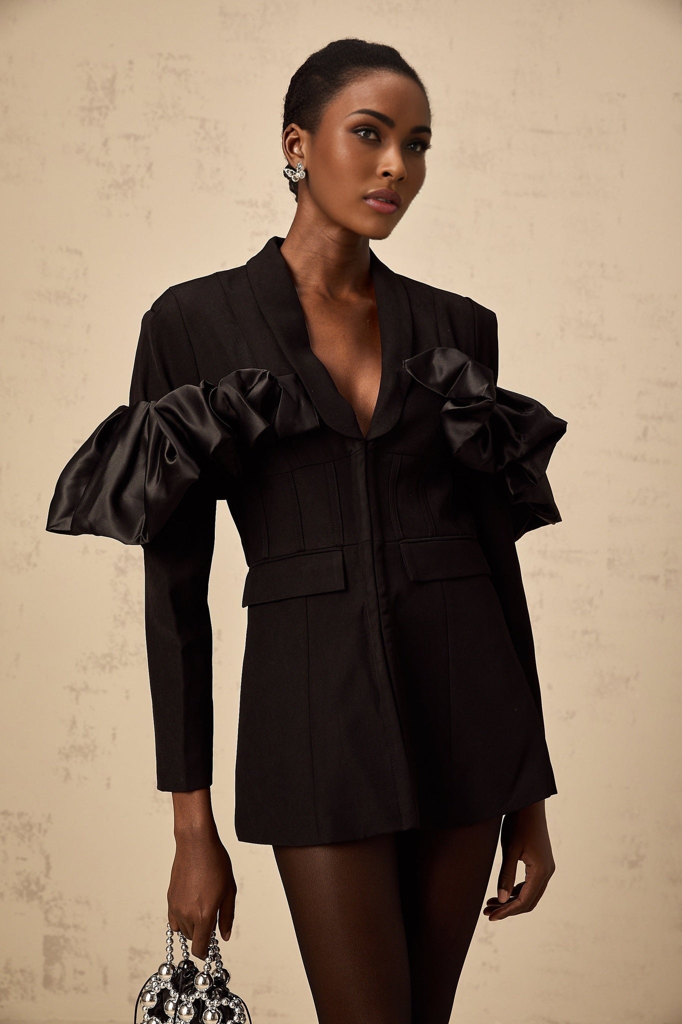 A black blazer with panelled design and boned structure featuring a tailored fit and structured silhouette