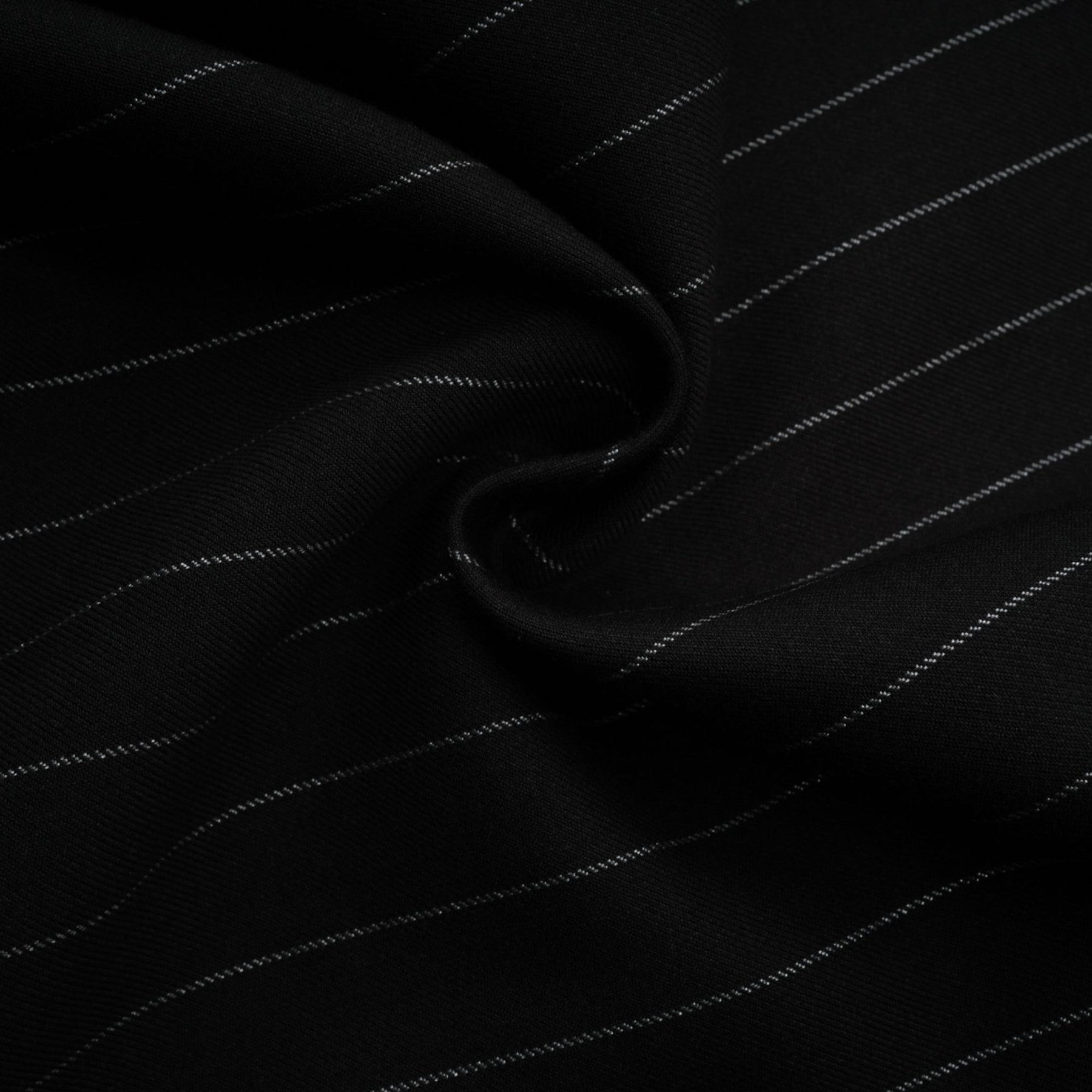 A black blazer with white stripes featuring an open back design worn by a model facing away from the camera