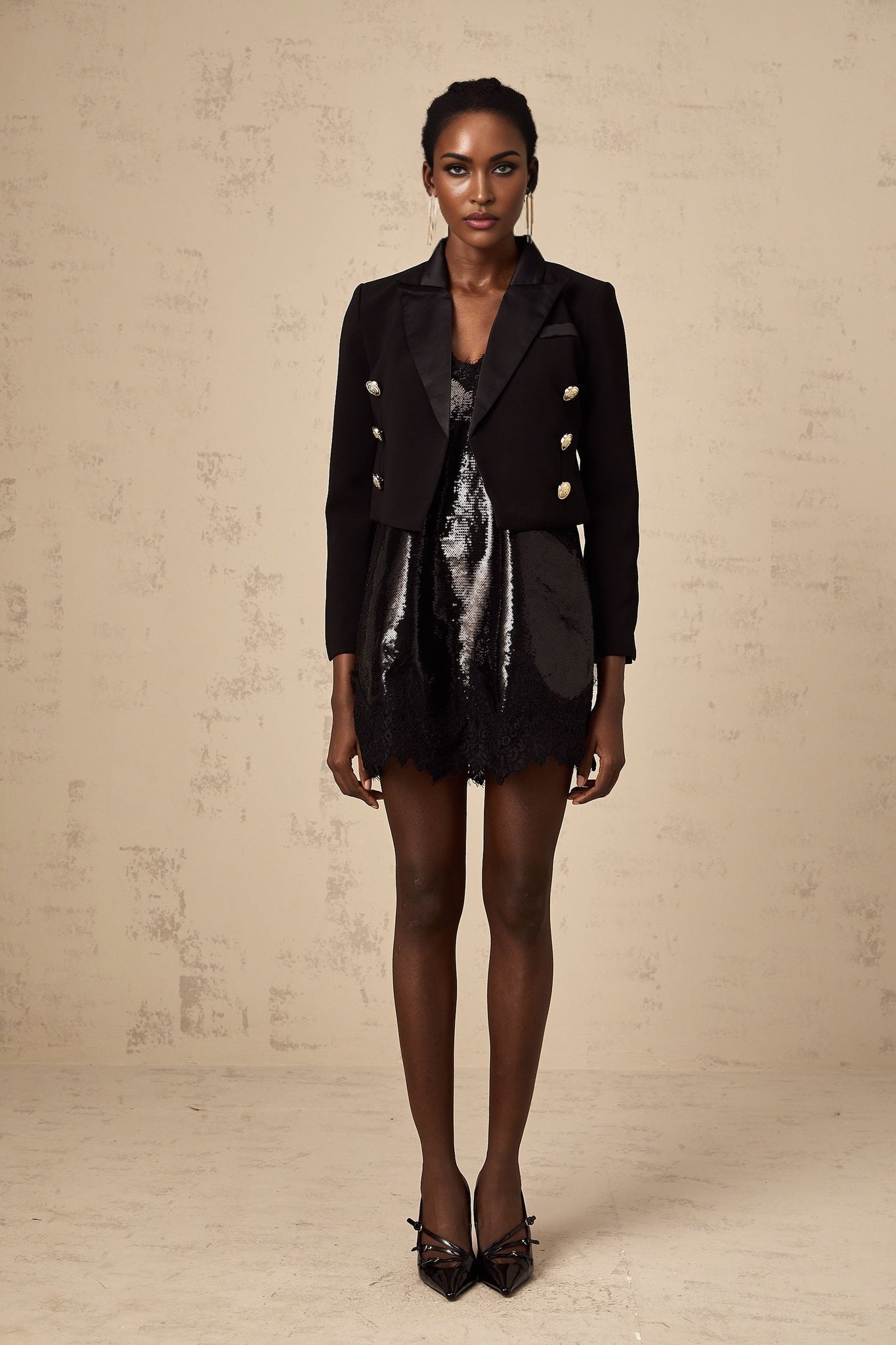 A black cropped blazer with doublebreasted front closure and tailored fit named Giulia