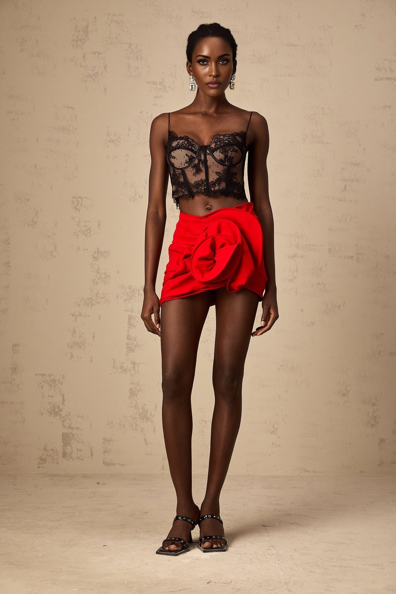 A black cropped vest top with delicate floral lace pattern throughout