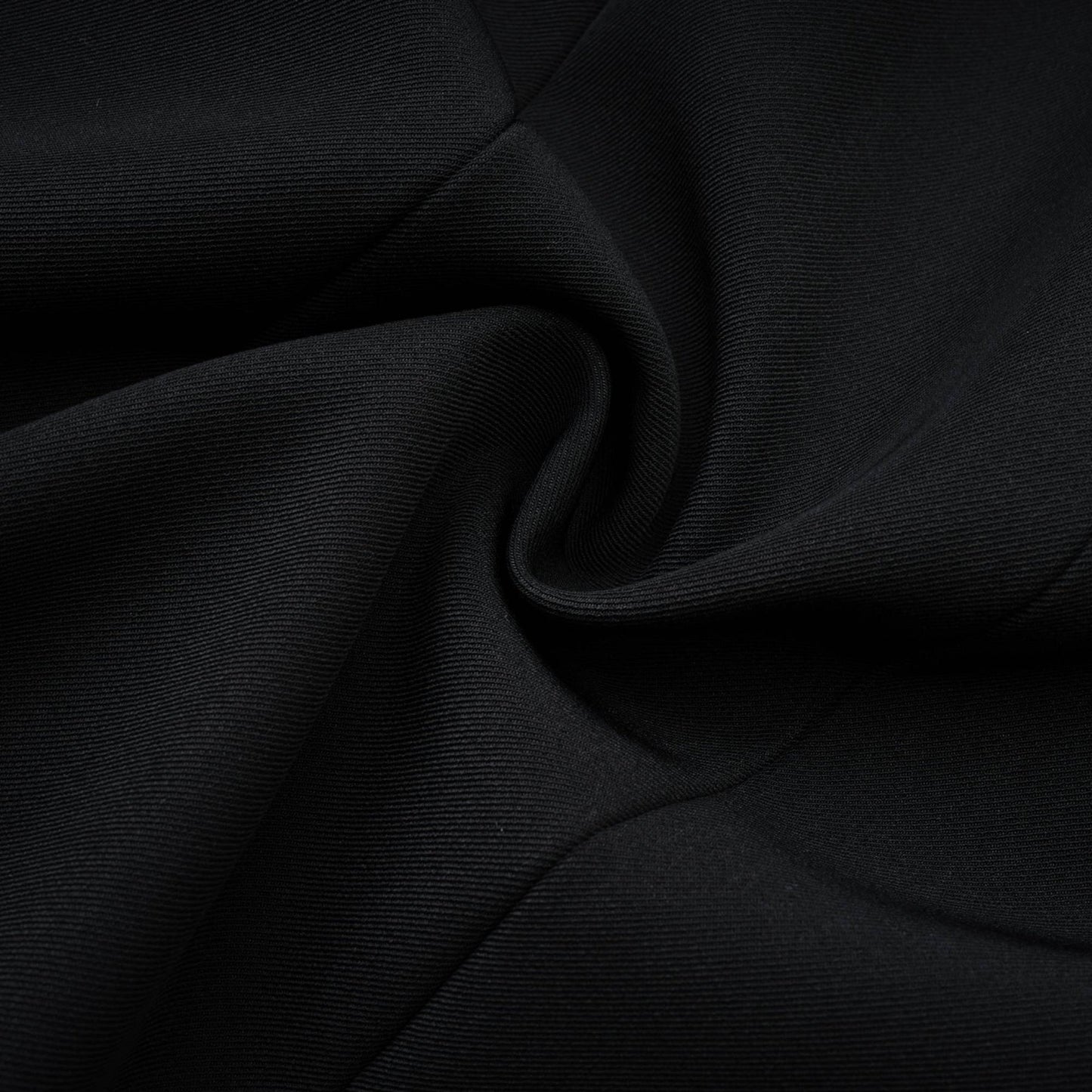 A black crystal embellished mini dress with a sleek silhouette and shimmering details