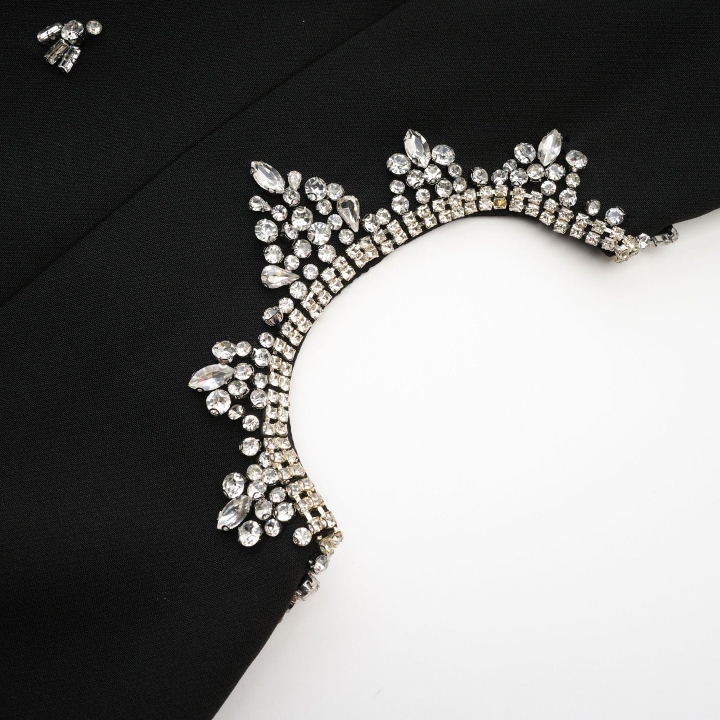 Black sleeveless dress with accentuating contrast colors classy round neck unique cutout design sparkling crystal embellishments rear zip fastening and stylish thigh length Made of 100% Polyester
