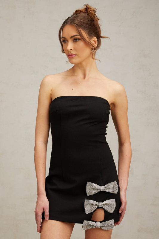 A black fitted mini dress with studded details and a decorative bowknot embellishment