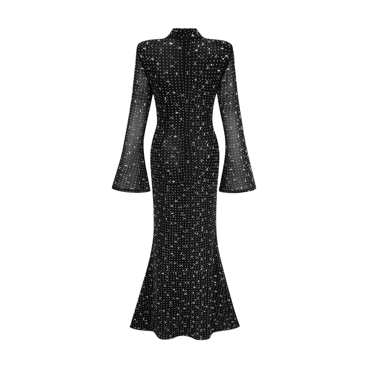 A black floor length maxi dress with sheer elements and embellished details worn by a model standing against a plain background