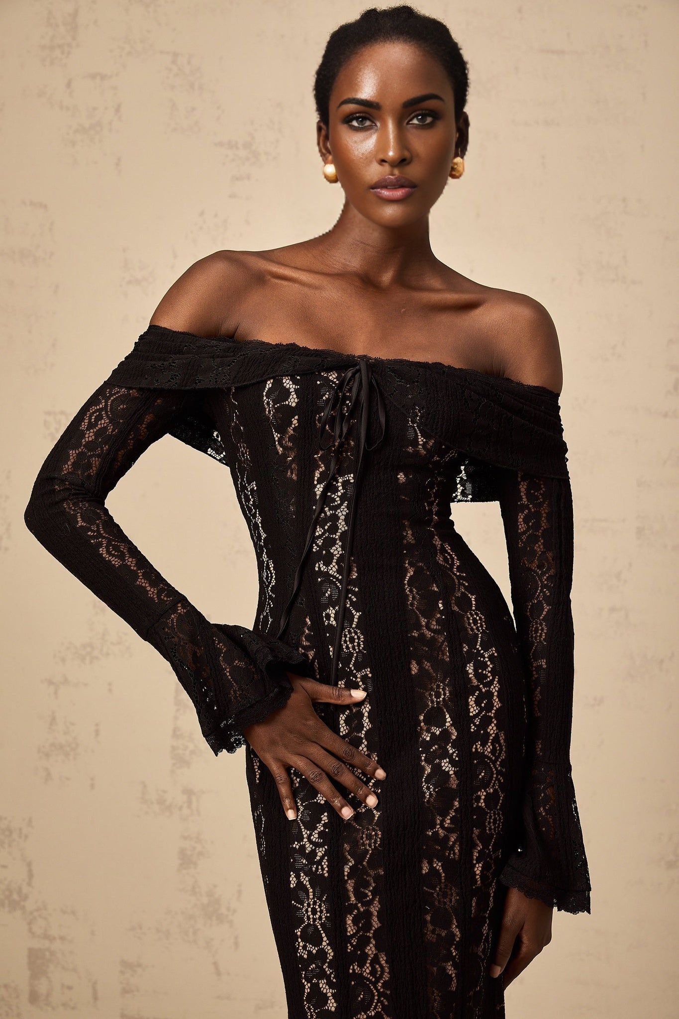 A black floral lace midi dress with flared cuffs named Emeline featuring an elegant design and delicate floral pattern throughout