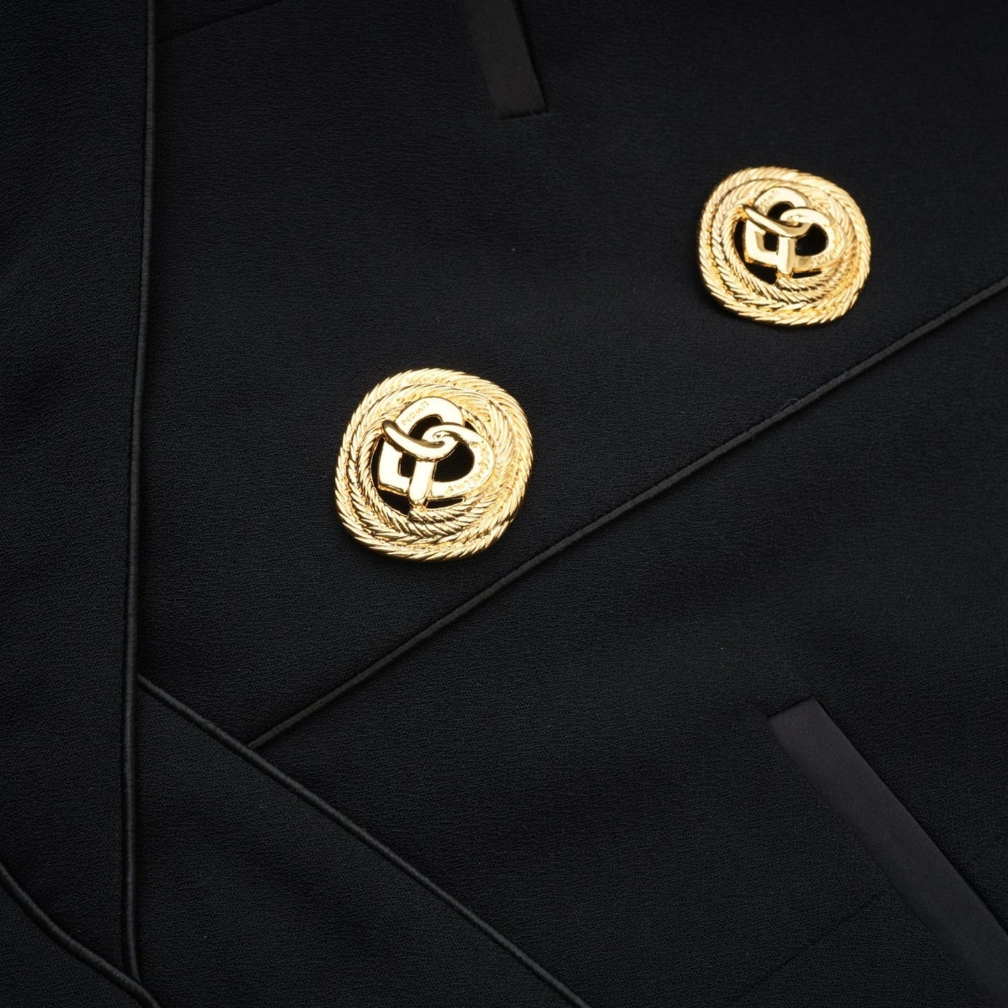 Elegant black dress with halter neck sleeveless design and front golden button detail
