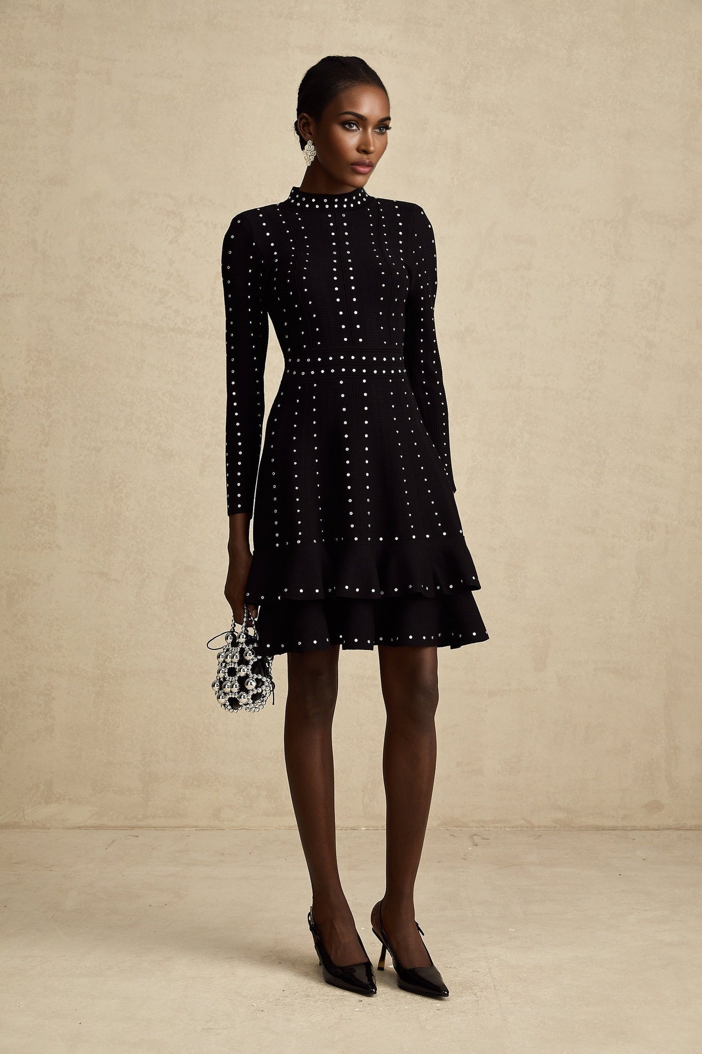A black knitted mini dress with embellishments and ruffled details named Fabienne