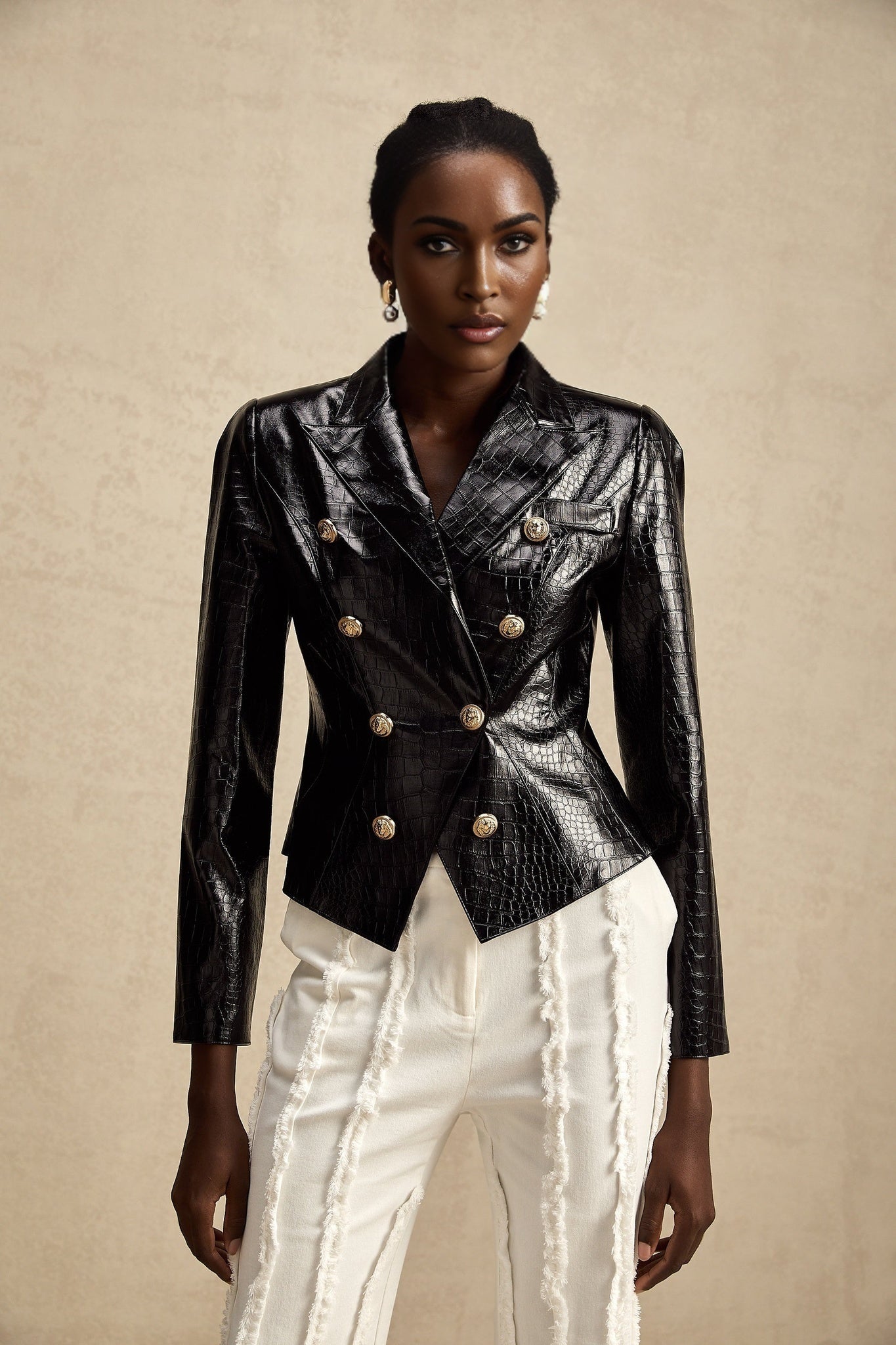 A black leather jacket with a cinched waist design featuring the Elodie brand