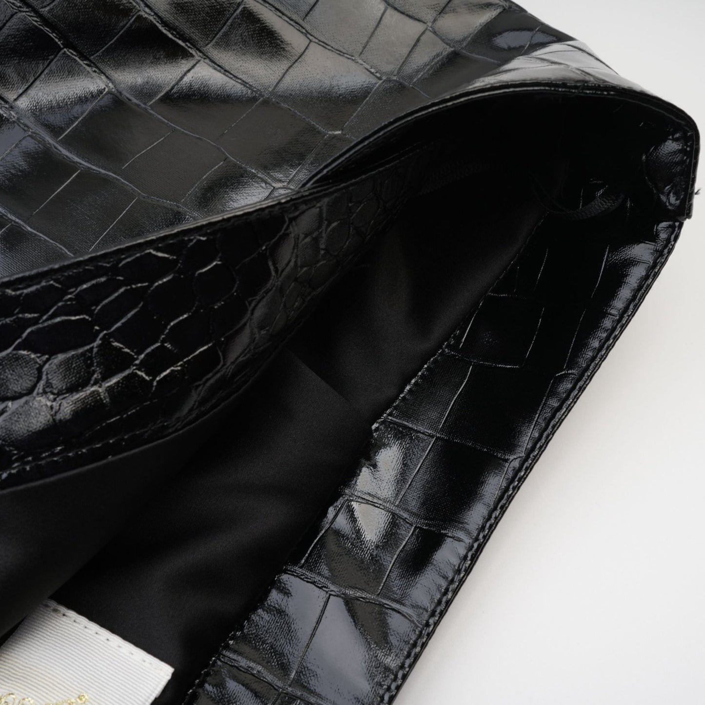 A jet black dress with a leatherlike feel stylish buckle and thighcut design made of premium polyester %