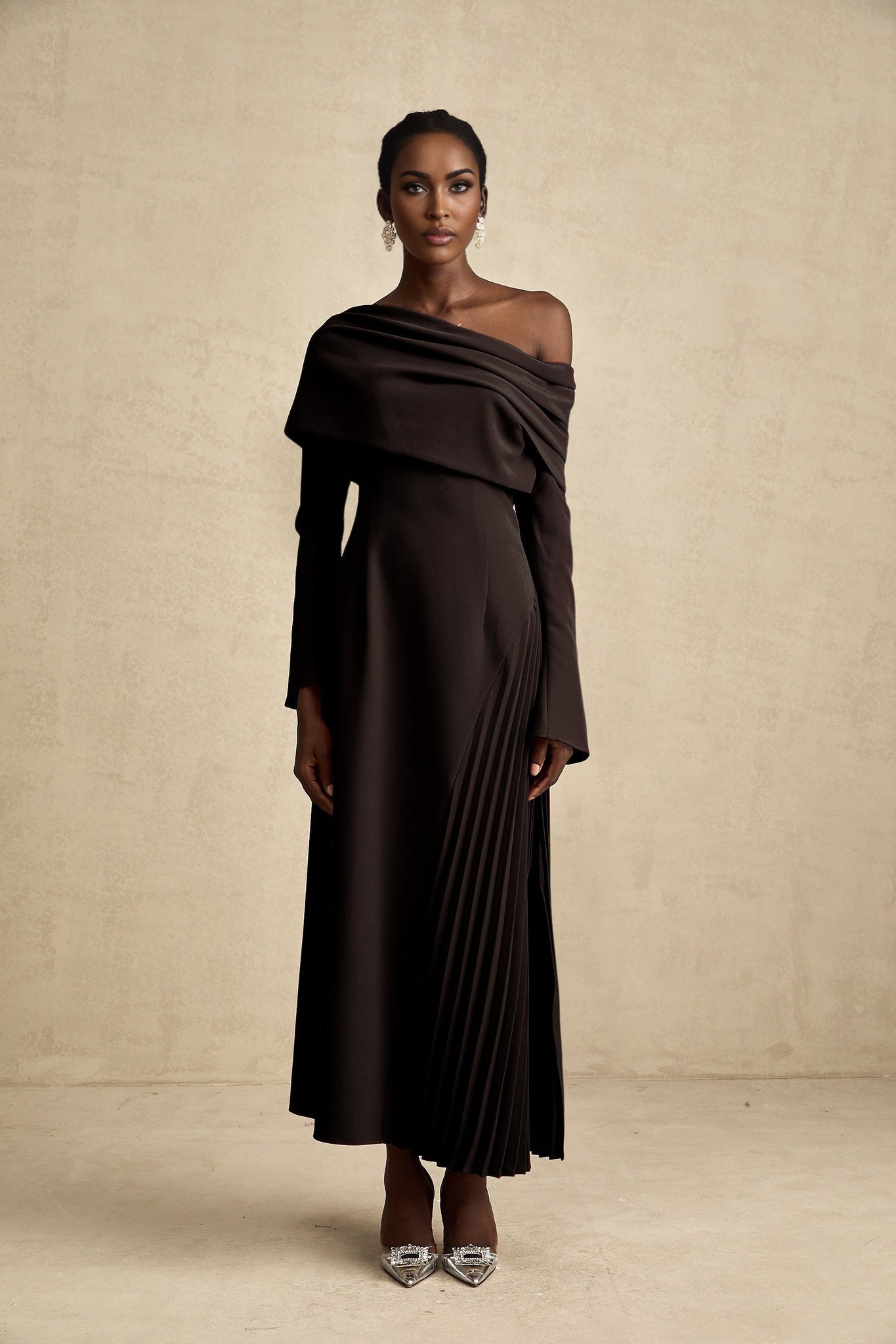 A black long maxi dress with a high slit and pleated design suitable for Valentines Day occasion