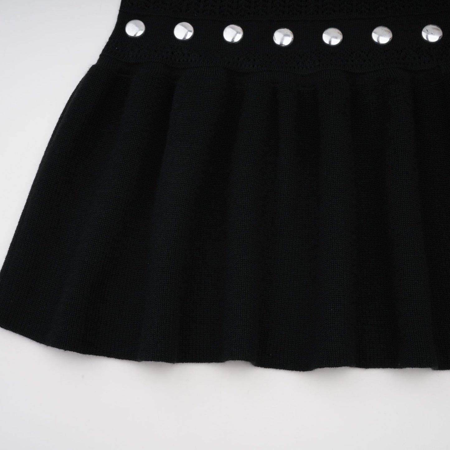 A black long maxi dress with crochet knit pattern and studded details designed by Chloe