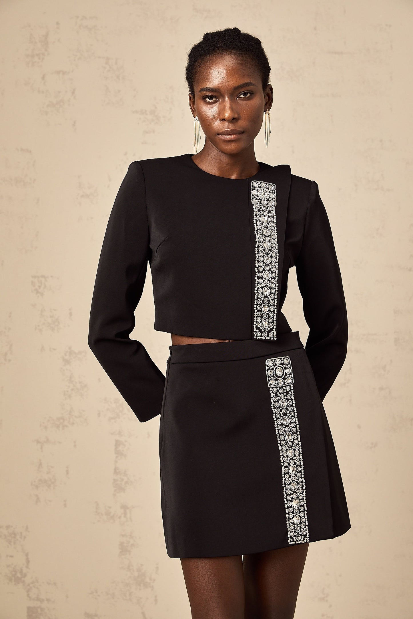 A black matching set consisting of a top and skirt embellished with crystal details named Nadia