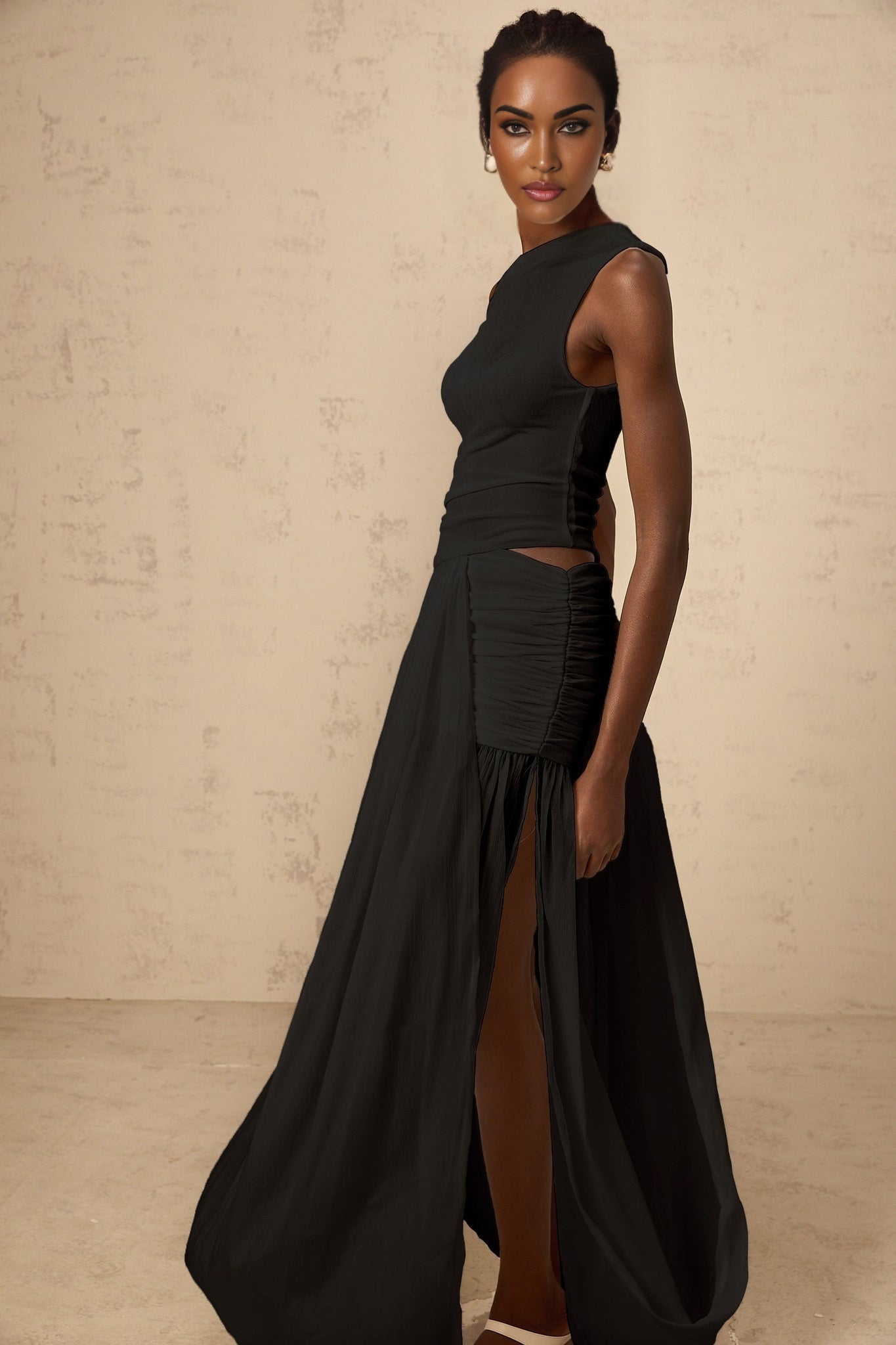 A black maxi dress with a single shoulder strap and shirred panel detailing
