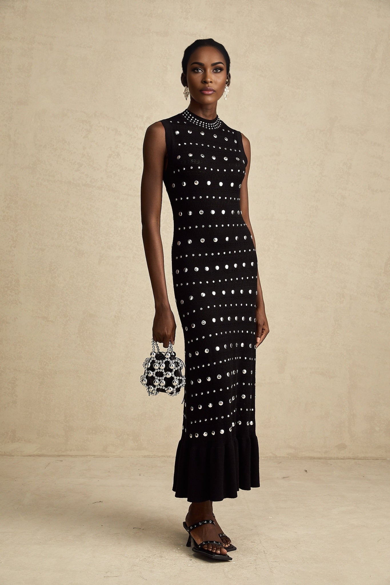 A black maxi dress with crochet knit pattern and studded details by Chloe