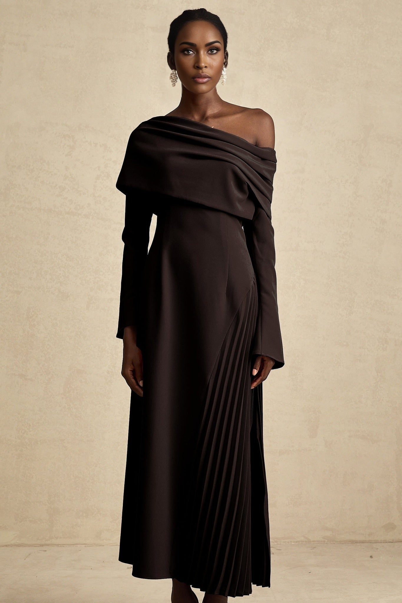 A black maxi dress with high slit and pleated design suitable for Valentines Day occasion