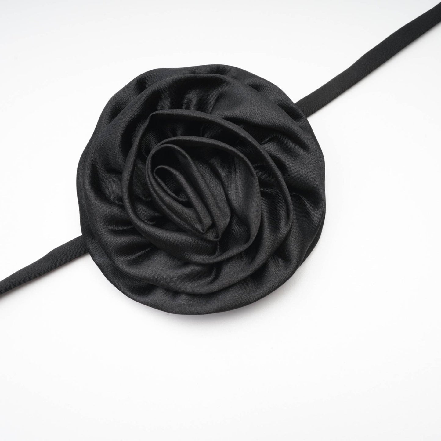Black anklelength dress with spaghetti straps flower decoration at the neck sleeveless and open back made of 100% Polyester