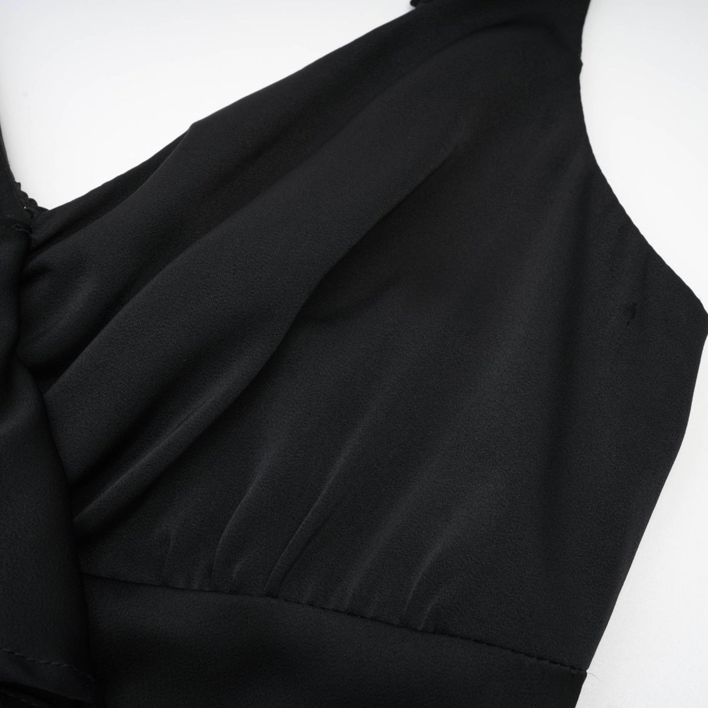 Black sleeveless dress with spaghetti straps flower decoration at the neck ankle length open back made of 100% polyester