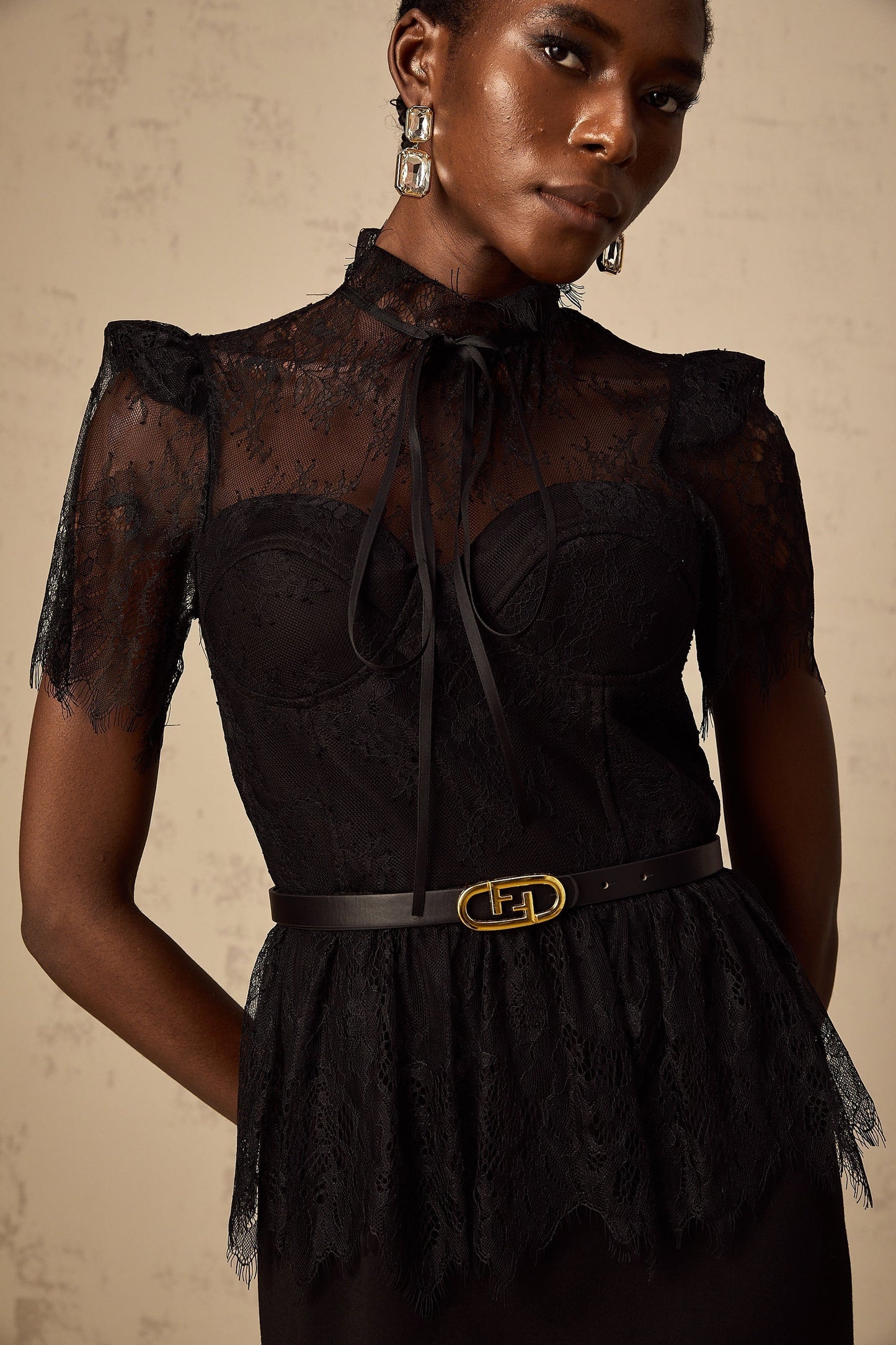 A black midi dress with guipure lace panels featuring a fitted silhouette and no belt Thérèse style