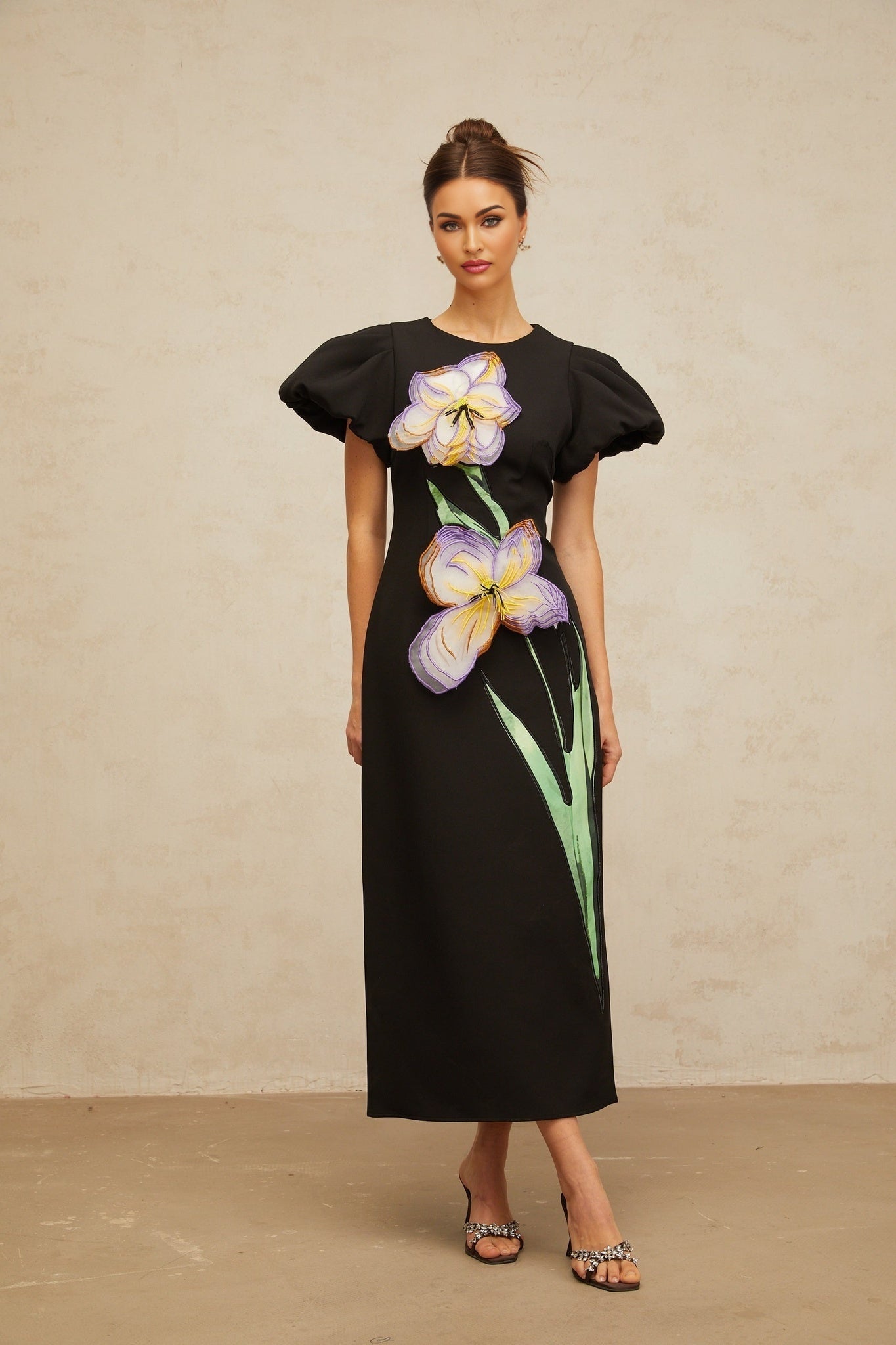 A black midi dress with sequin embellishments and floral embroidery details