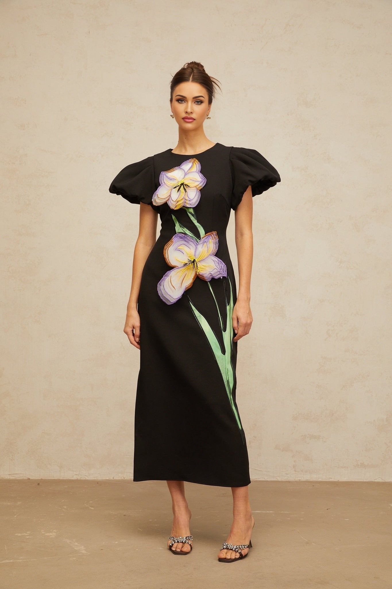 A black midi dress with sequined floral embroidery named Irene featuring a fitted silhouette and intricate detailing