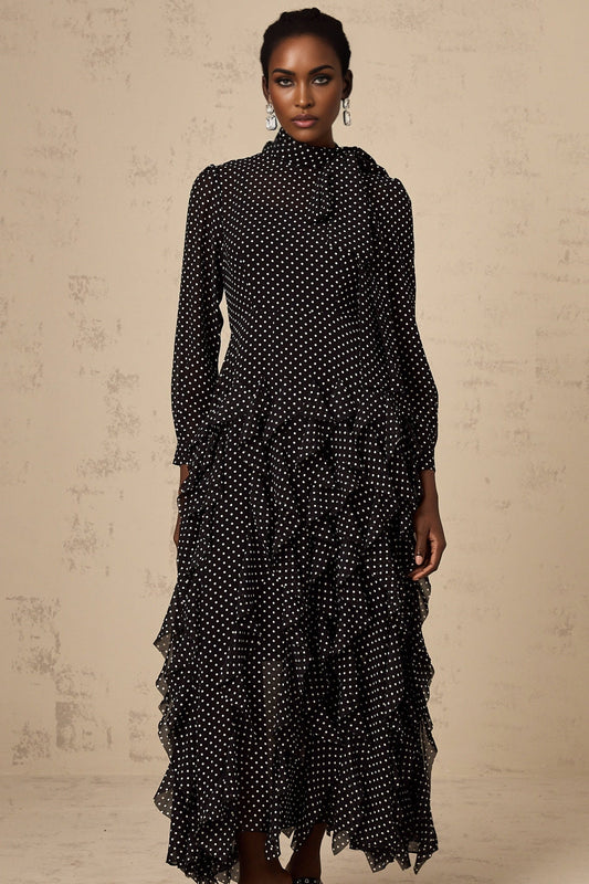A black midi dress with white polka dots featuring ruffled details and a feminine silhouette