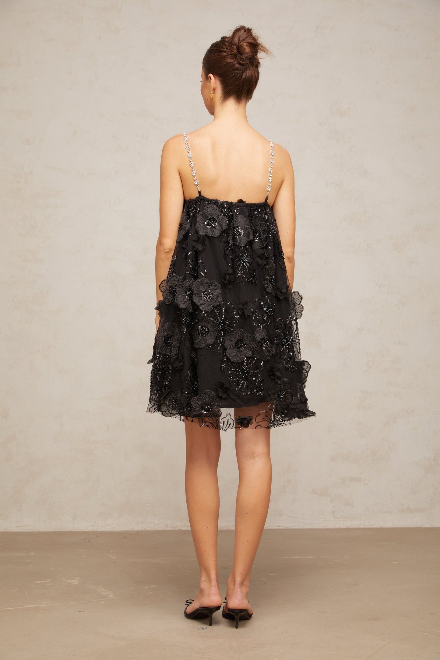 A black mini dress with a floral pattern and crystal embellishments called Suzette