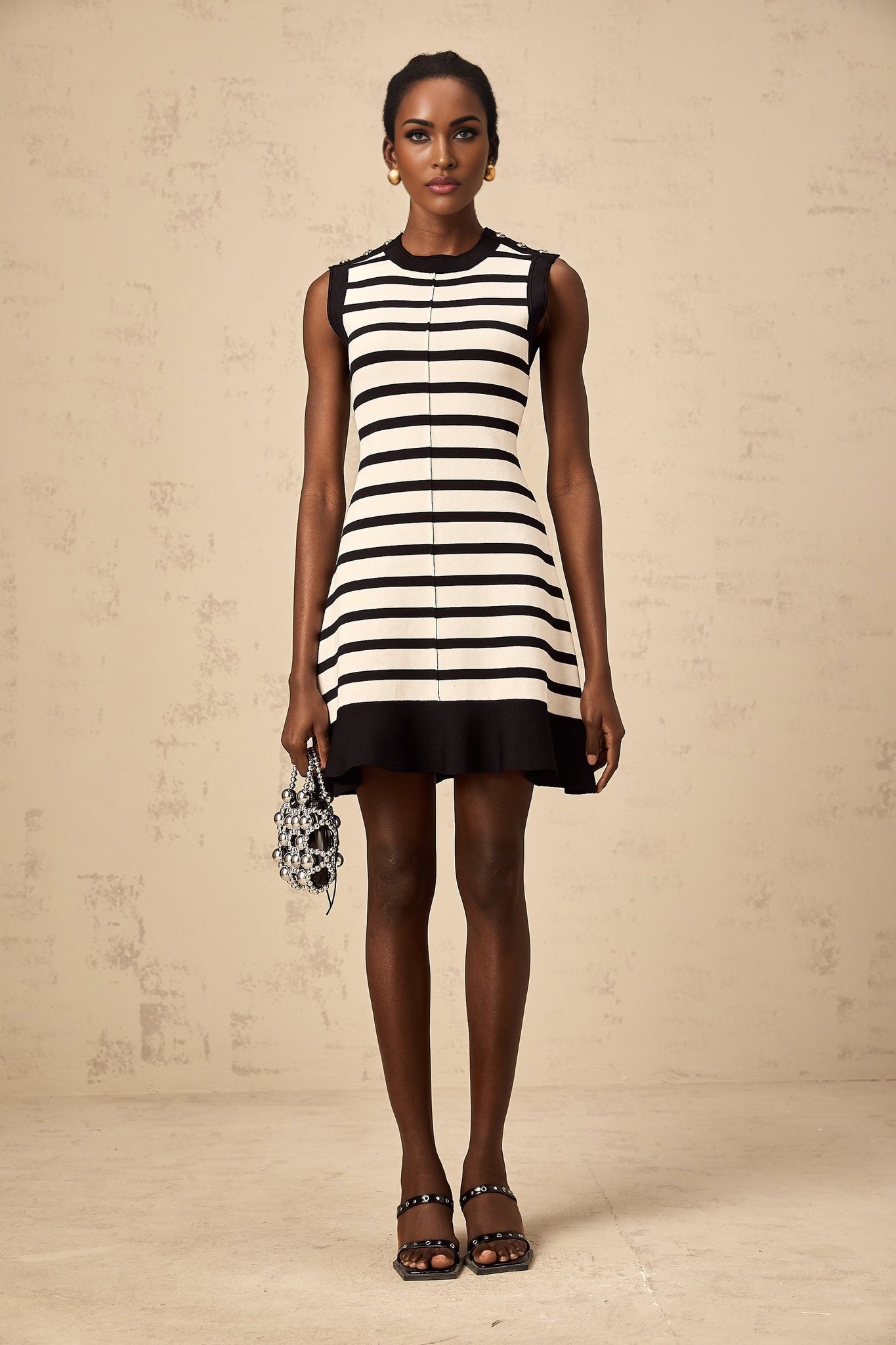 A black mini dress with horizontal stripes in a knit fabric named Heloise