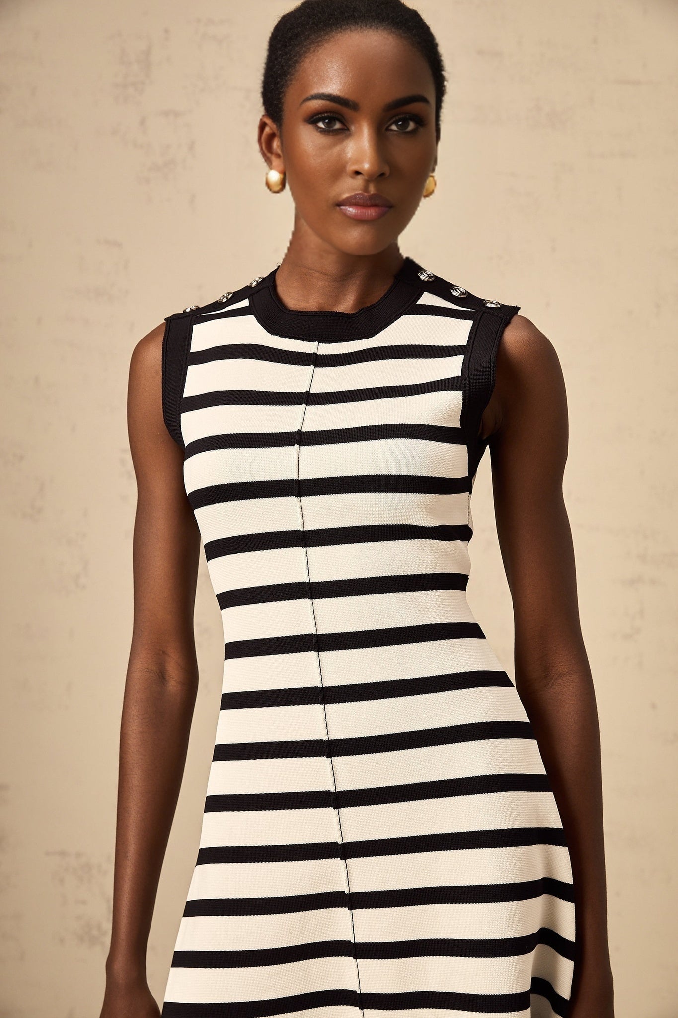 A black mini dress with horizontal stripes in a knit fabric style named Heloise
