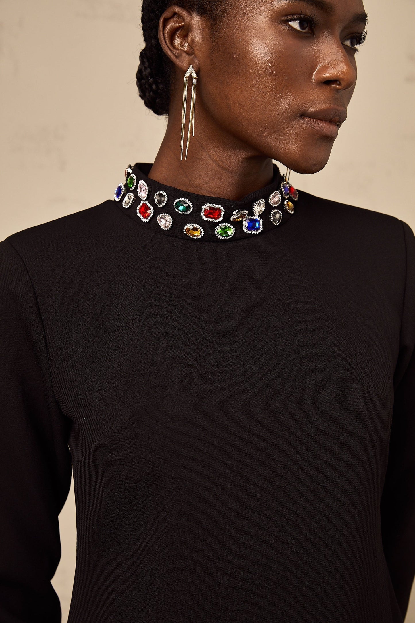 A black mini dress with long sleeves and crystal embellishments named Juliette