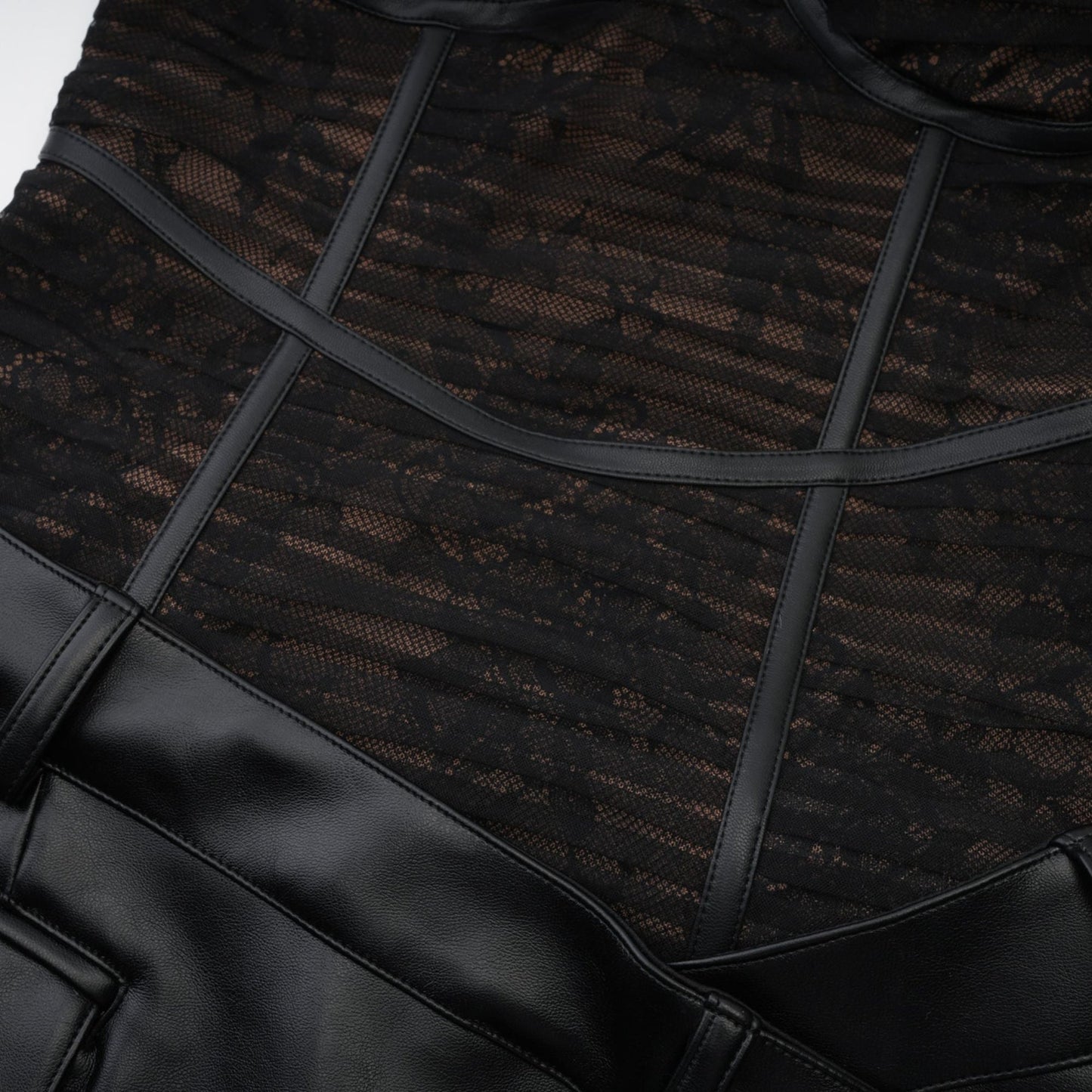 Formfitting black dress with mesh details and a fauxleather finish