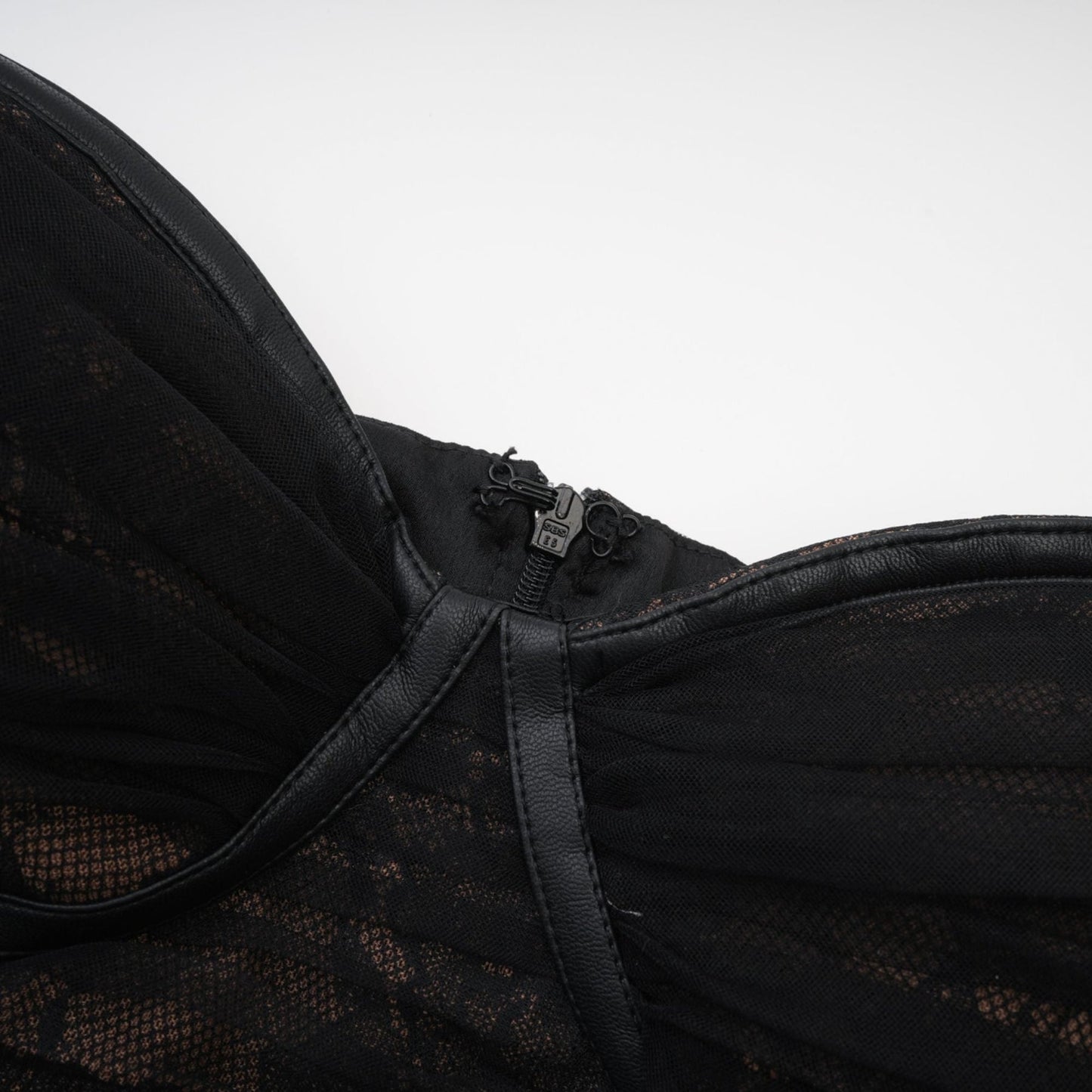 Chic Fauxleather black dress with mesh detailing and an asymmetric design featuring a bustier style and rear zip fastening