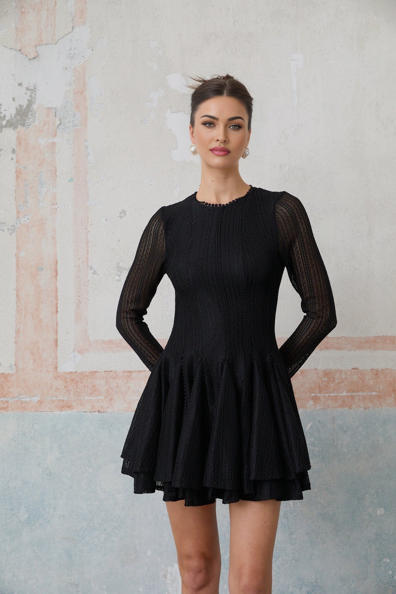 A black mini dress with puff sleeves and pointelle knit detailing named Helene